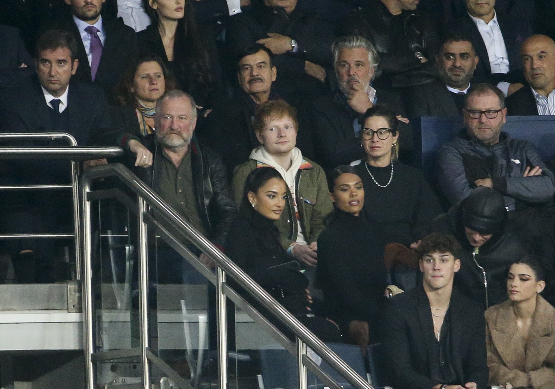  Ed Sheeran is pictured sitting between his father John Sheeran and his wife Cherry Seaborn at a match between Paris Saint-Germain (PSG) and Manchester City (Man City) at Parc des Princes stadium on September 28, 2021, in Paris, France | Source: Getty Images