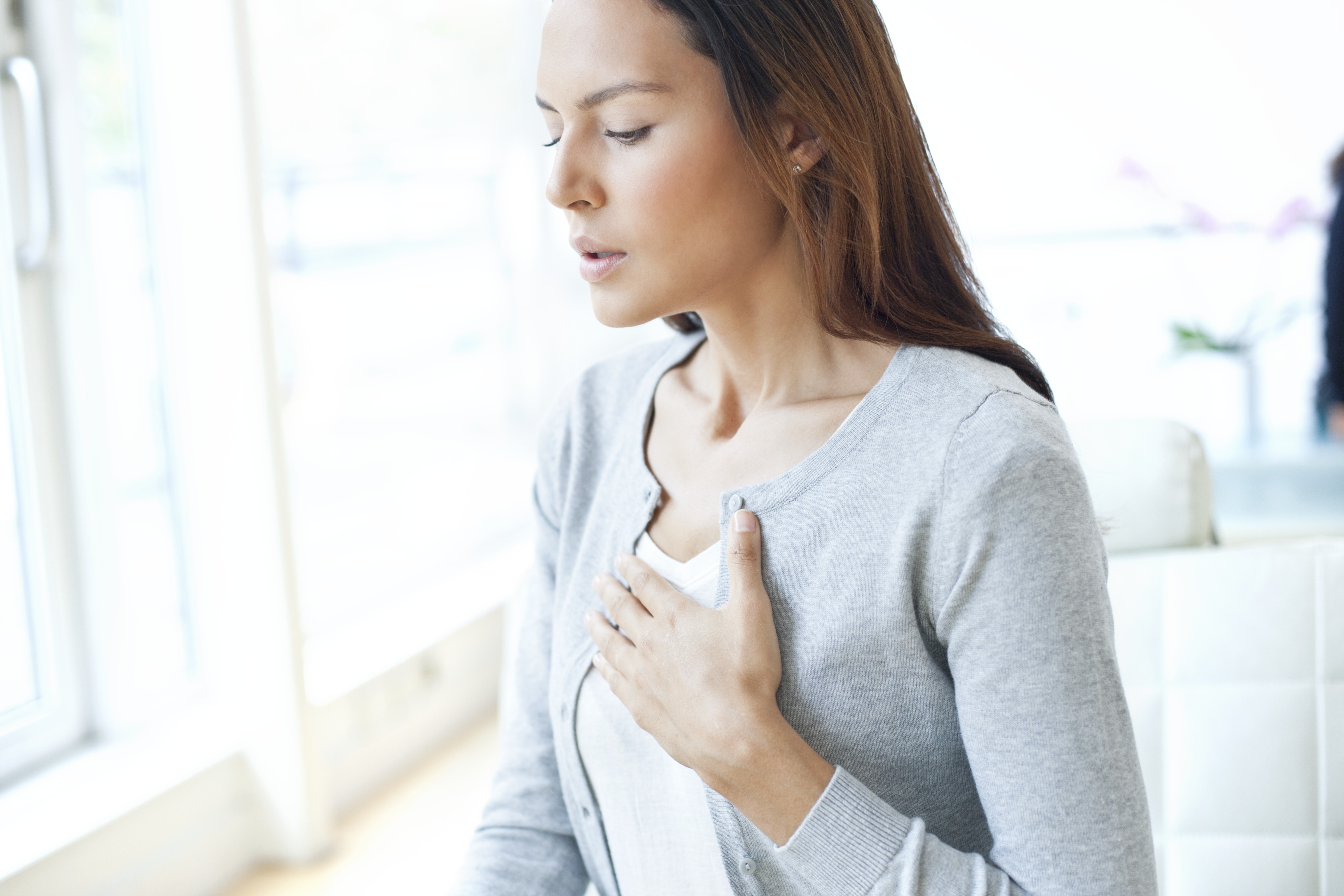 Young woman with hand on chest | Source: Getty Images