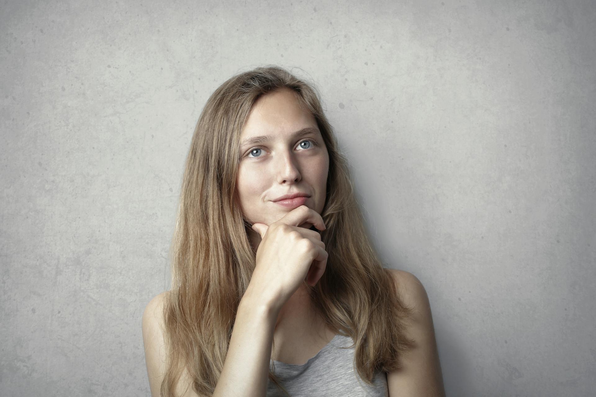 A thoughtful woman holding her chin | Source: Pexels