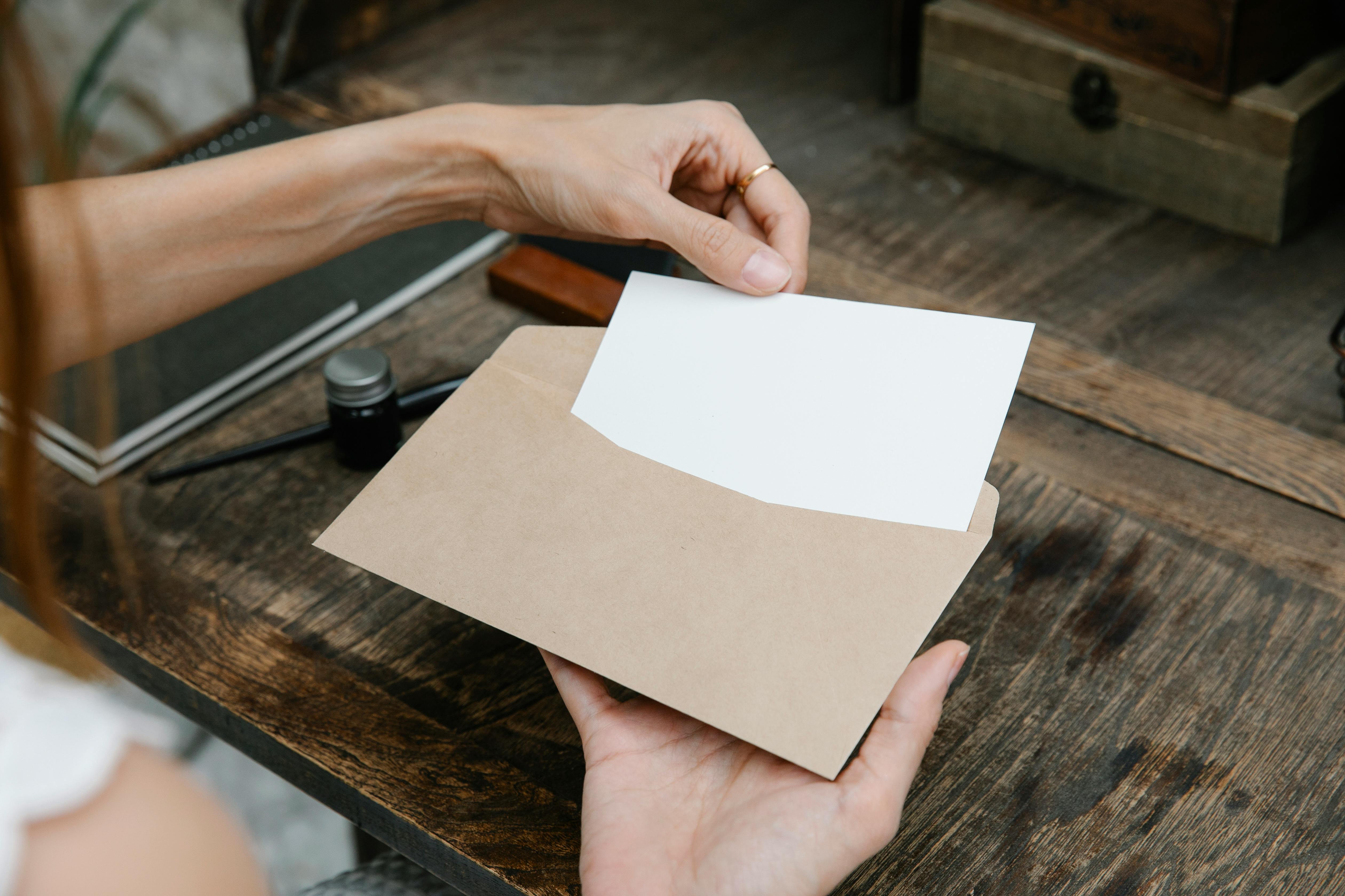 A woman opening an envelope to read a letter | Source: Pexels
