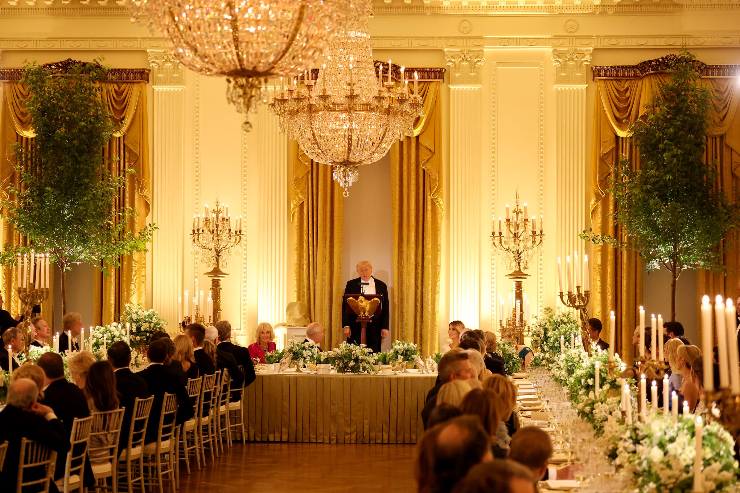 Donald Trump takes the stage to deliver remarks during a State Dinner in the White House East Room, April 28, 2026. | Source: Getty Images
