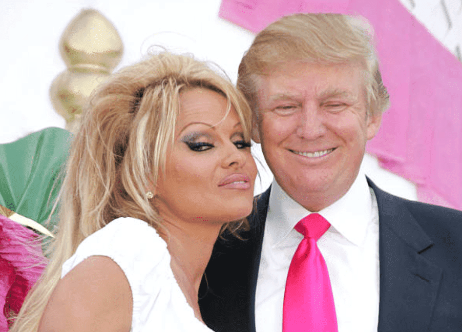 Pamela Anderson poses with Donald Trump for his birthday party and unveiling of New Bally Slot Machine at Trump Taj Mahal, on 13 June, 2005, Atlantic City | Source: Getty Images (Photo by James Devaney/WireImage)