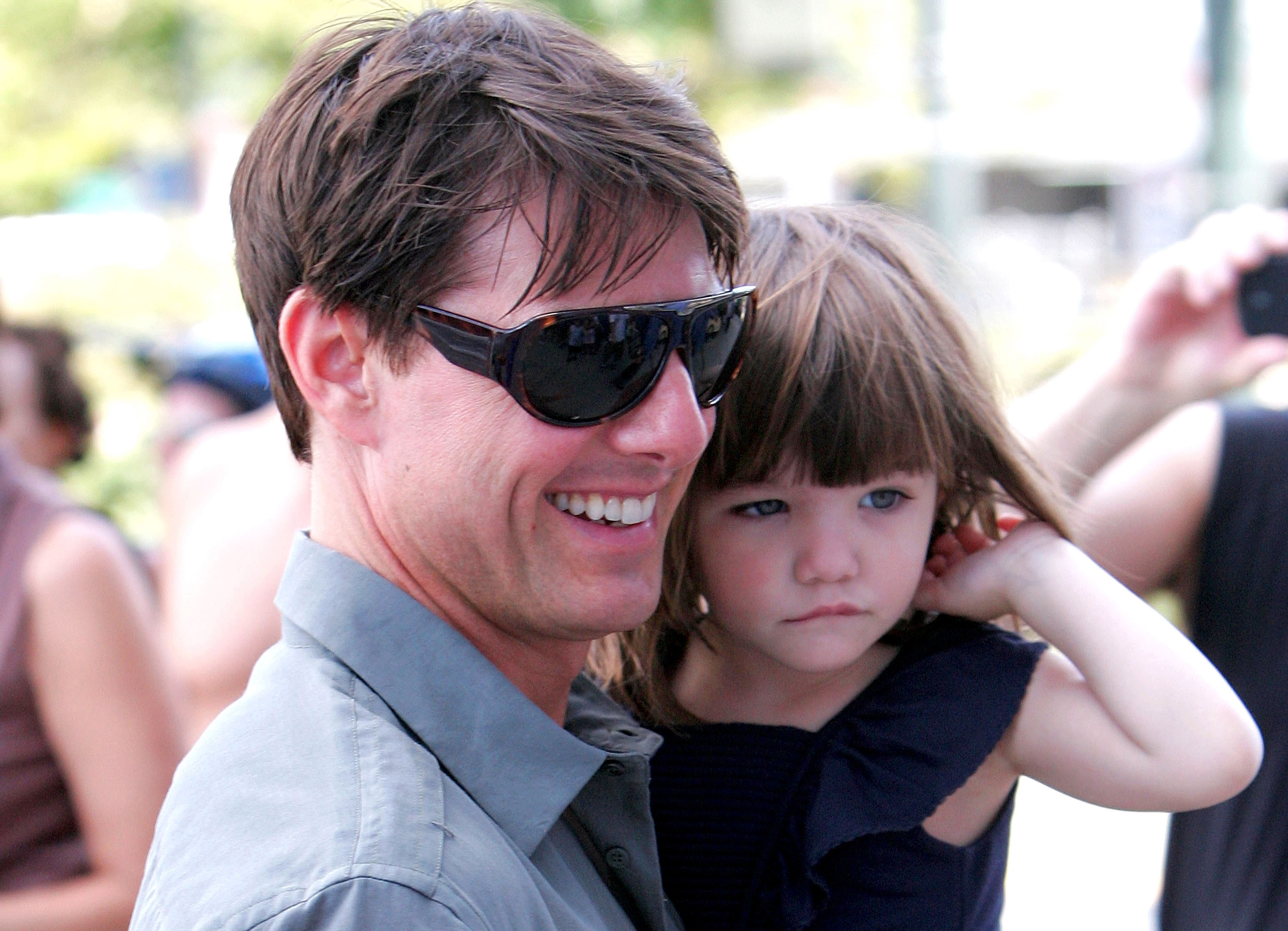 Tom Cruise carries Suri Cruise while the father and daughter are photographed during an outing in Manhattan. | Source: Getty Images