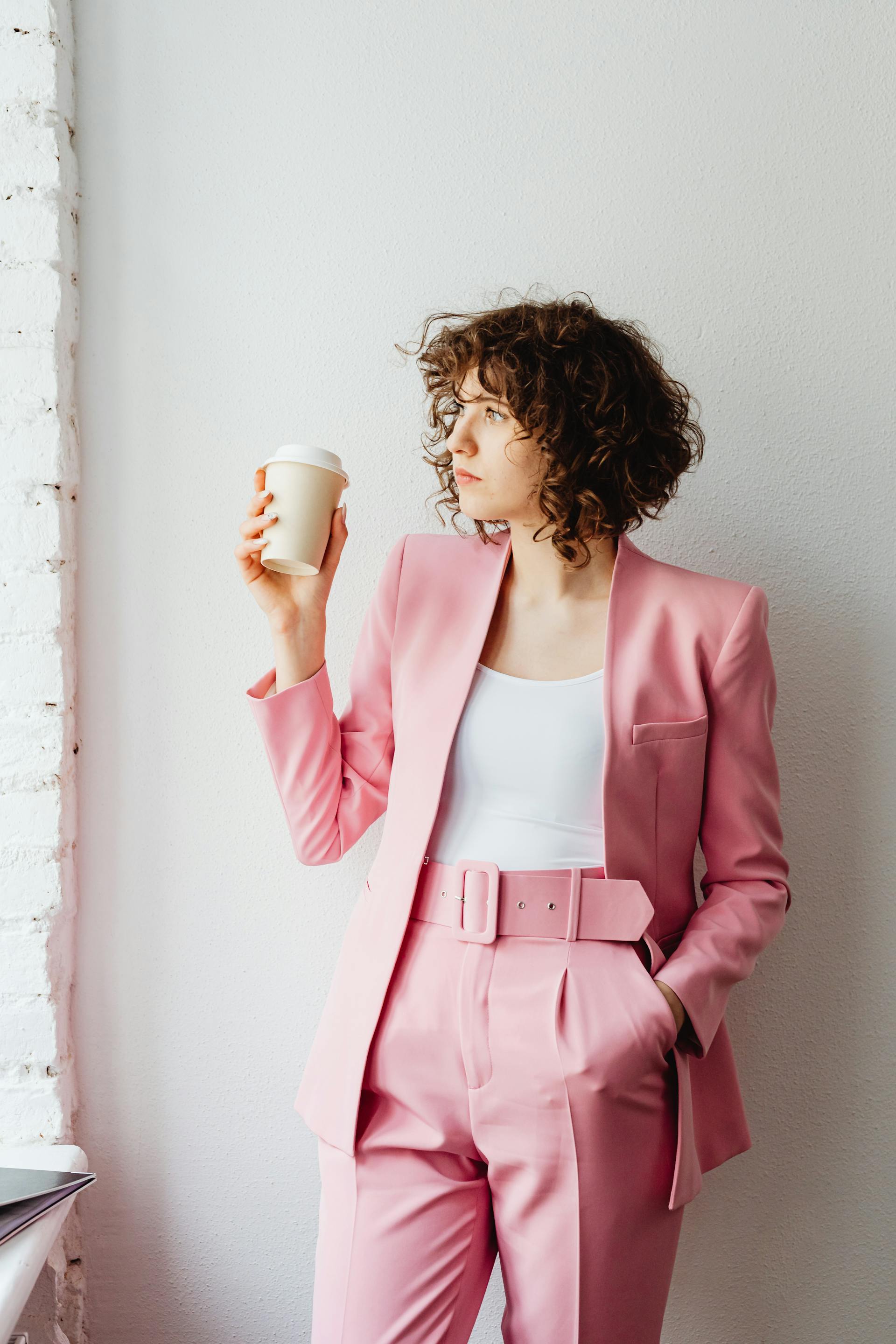 A woman holding a takeaway coffee cup | Source: Pexels