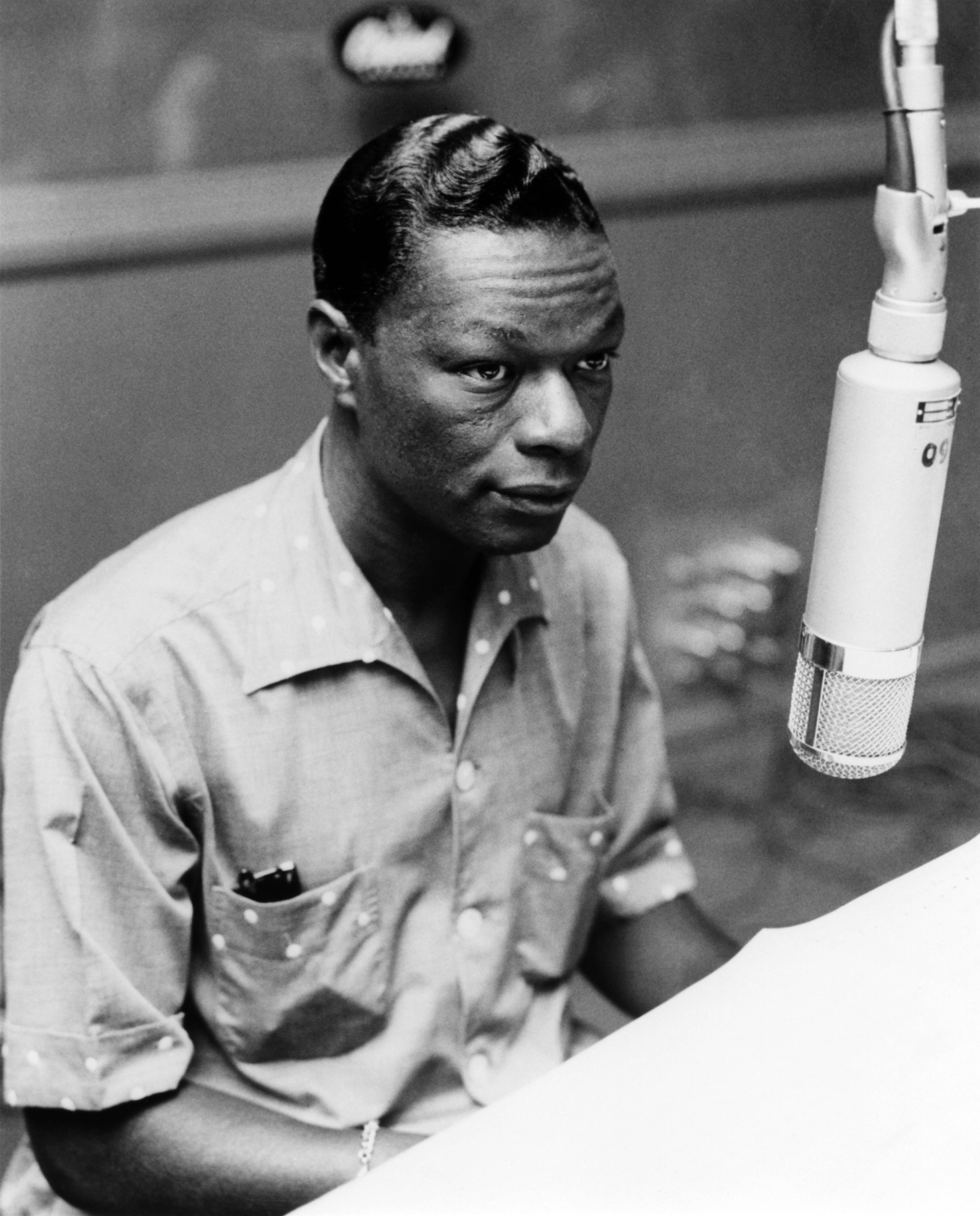 Photo of Nat King COLE; Nat King Cole playing the piano in the recording studio | Photo: Getty Images