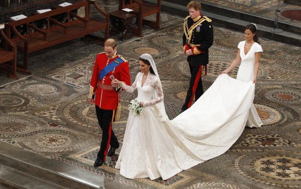 Prince William takes the hand of his bride Catherine Middleton, followed by Prince Harry and Pippa Middleton as they walk down the aisle inside Westminster Abbey on April 29, 2011, in London, England. | Source: Getty Images.
