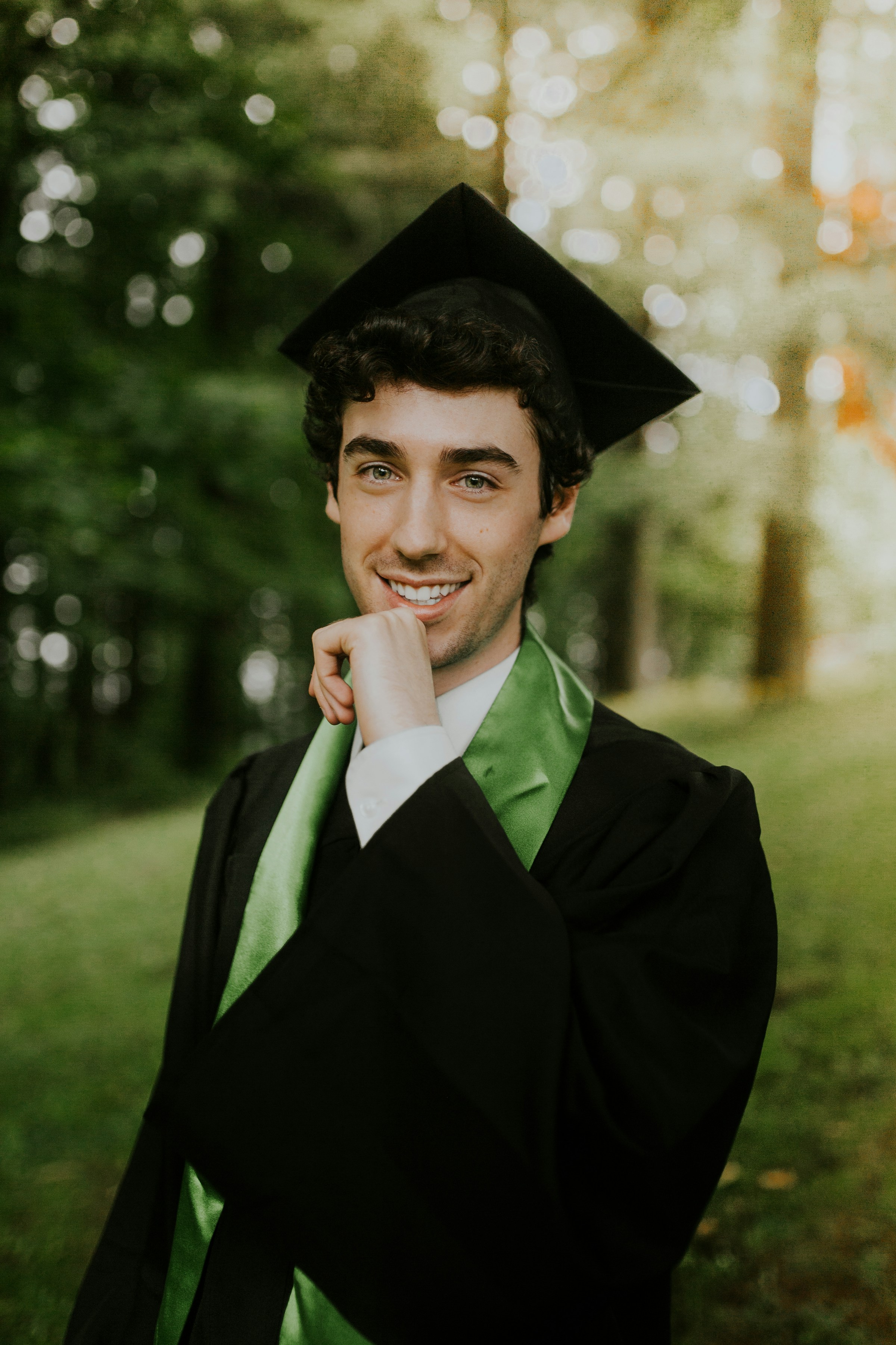A smiling young guy in a graduation gown | Source: Unsplash