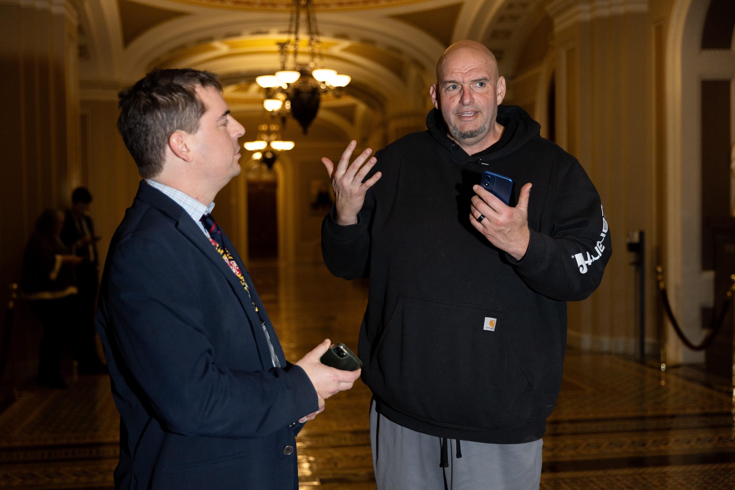 Senator John Fetterman and another man are seen following evening votes in the Senate in Washington, D.C., on January 20, 2025 | Source: Getty Images