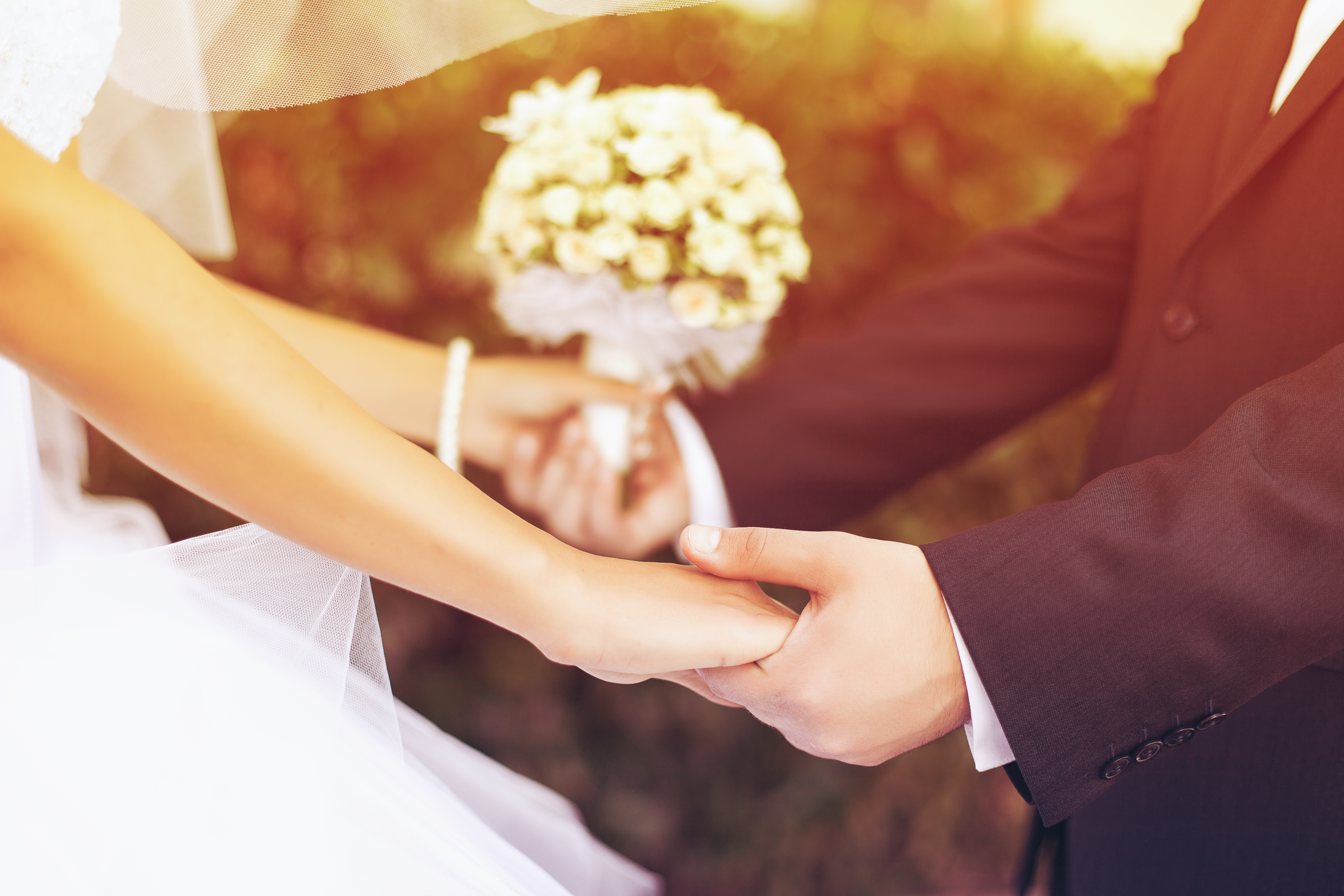 A bride and groom holding hands | Source: Shutterstock