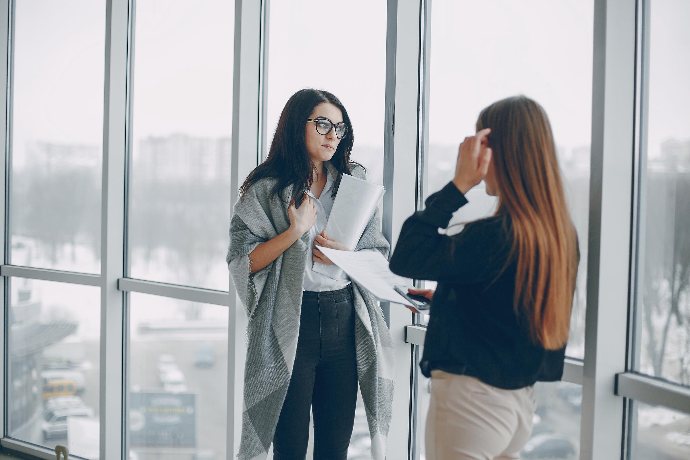 Two women chatting at workplace | Source: Freepik