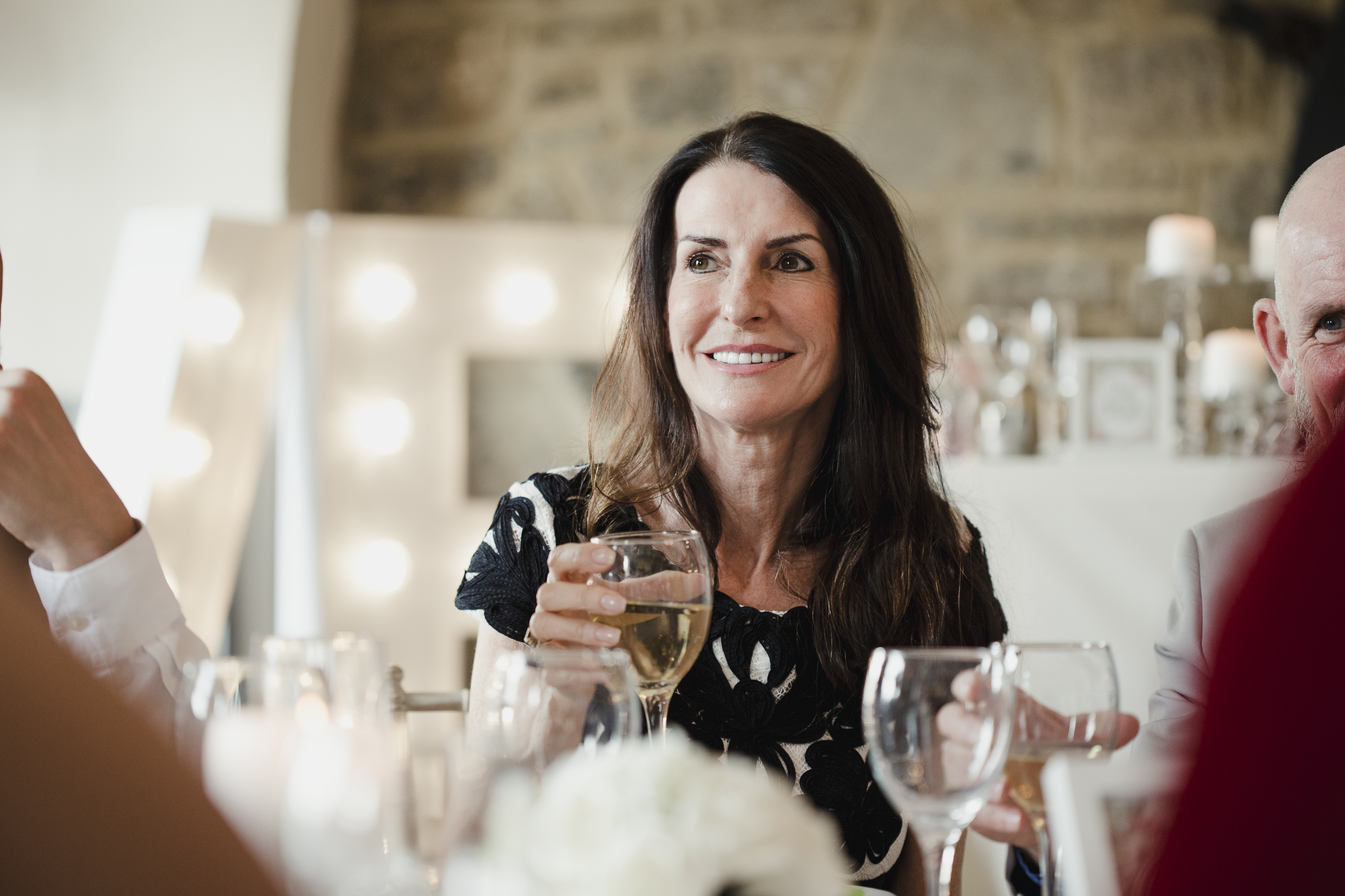 A woman toasting during a family gathering | Source: Shutterstock