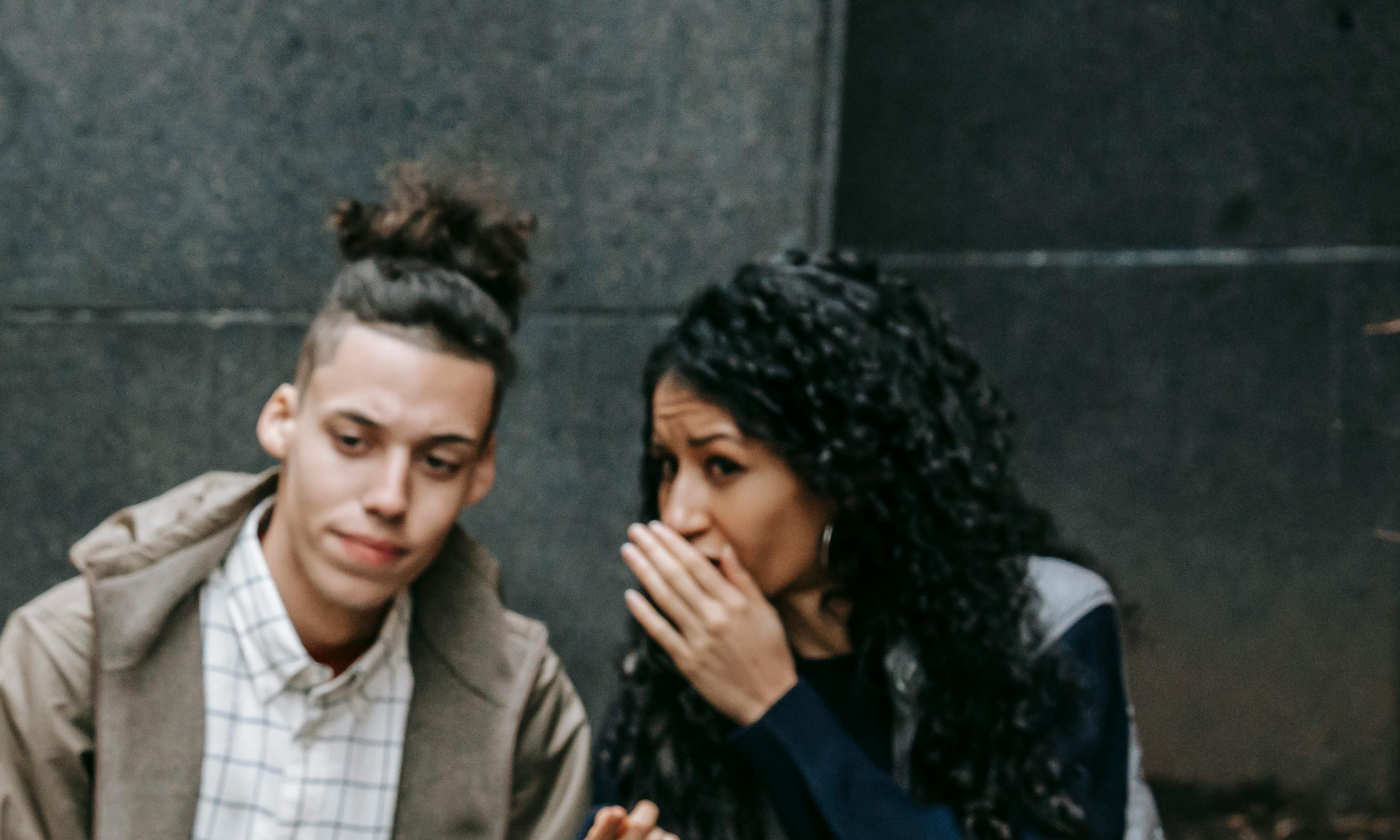 Neighbors gathering on the street, whispering and taking sides | Source: Pexels