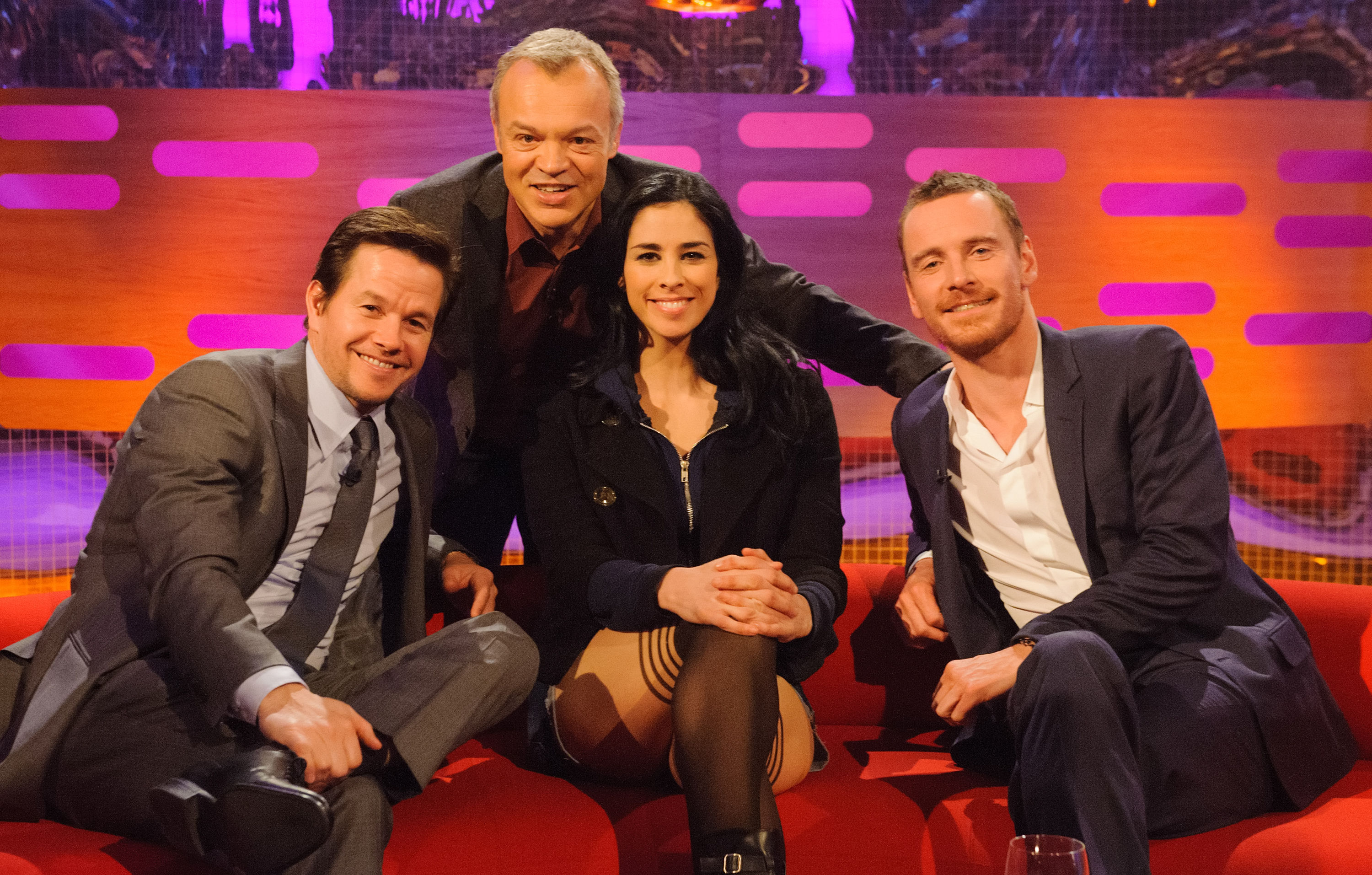 Mark Wahlberg, Sarah Silverman, and Michael Fassbender with Graham Norton during a recording of the Graham Norton Show, at the London Studios on 2 July 2013. | Source: Getty Images