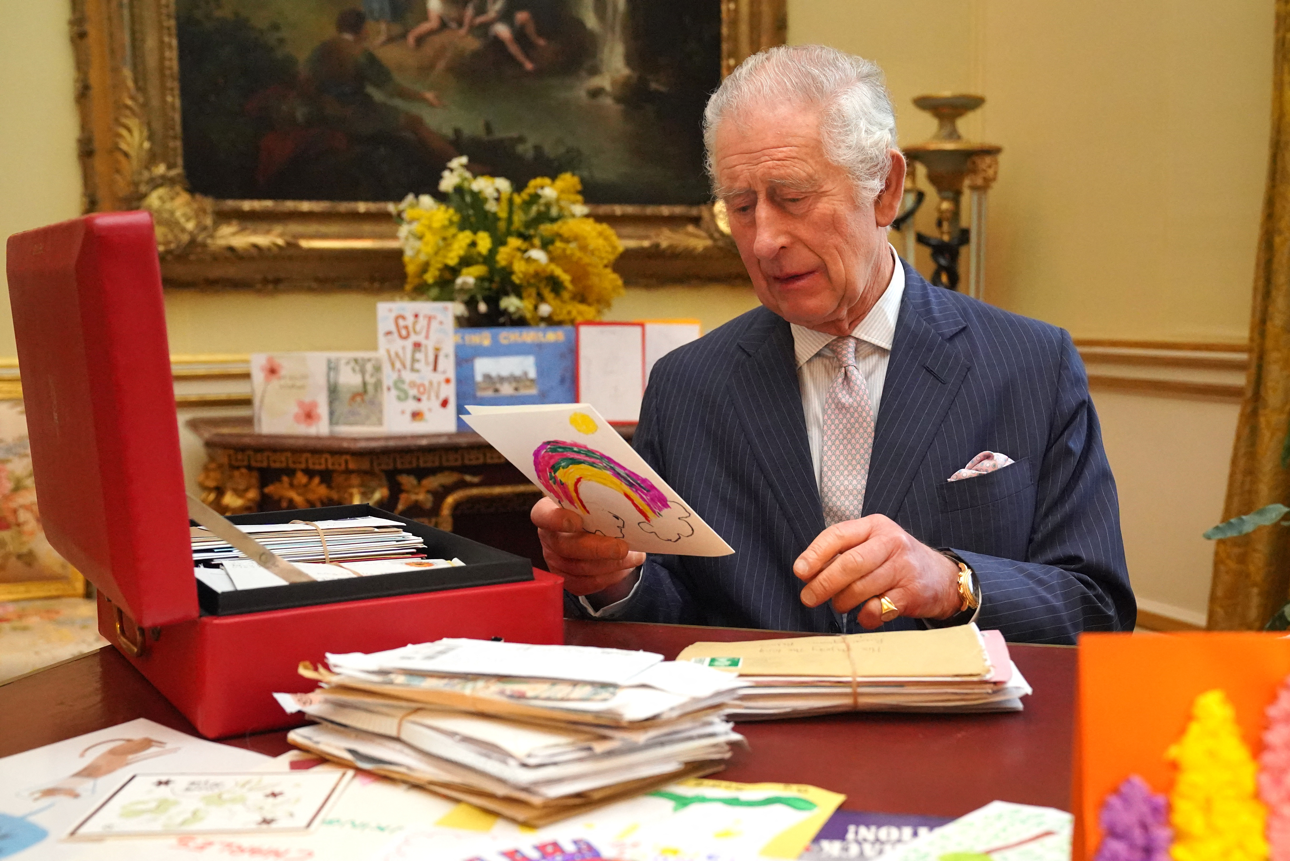King Charles III photographed reading cards and messages from supporters following his cancer diagnosis, on February 21, 2023 | Source: Getty Images