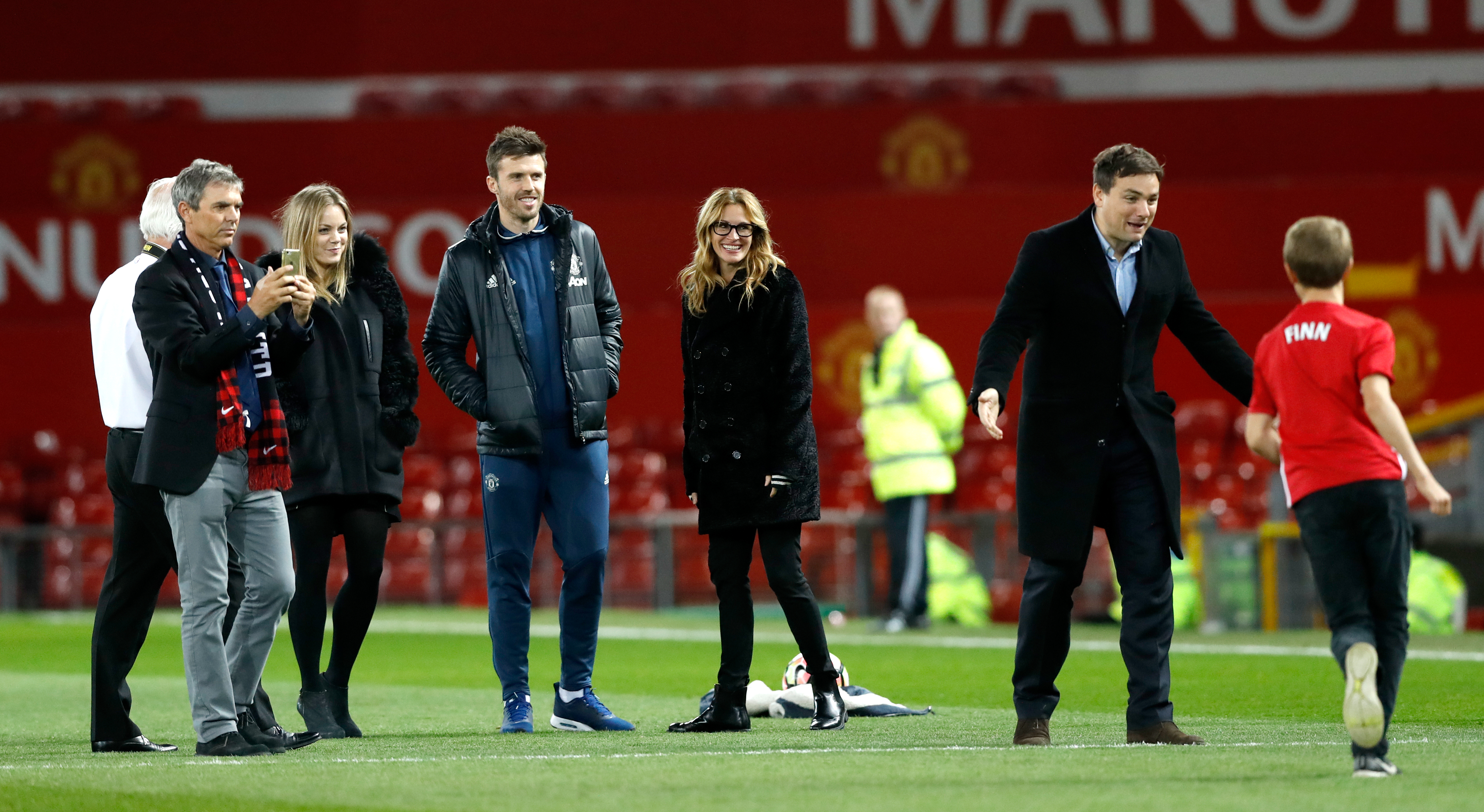Julia Roberts with her children on the field after the Premier League match at Old Trafford, London | Source: Getty Images