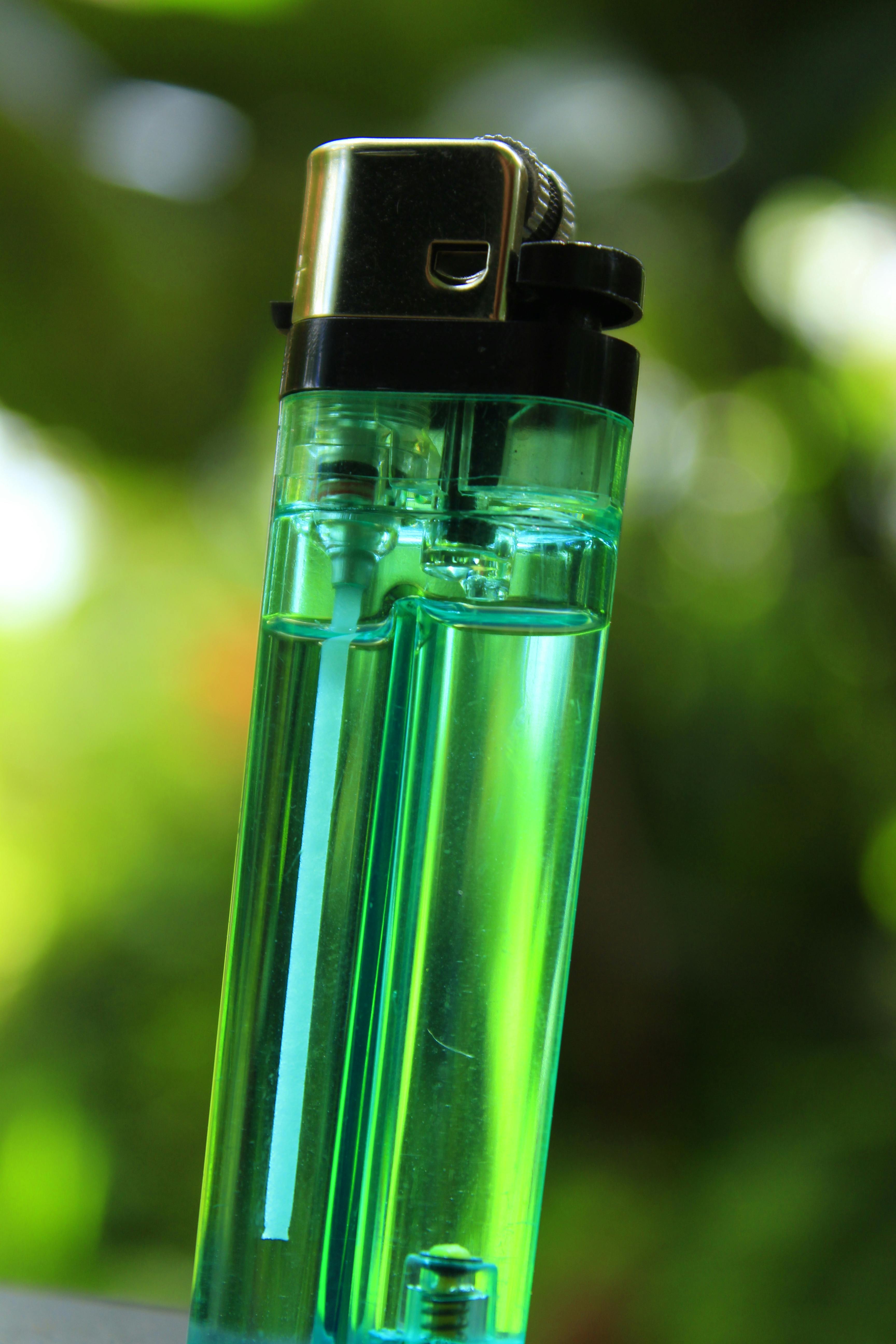A green disposable lighter | Source: Pexels
