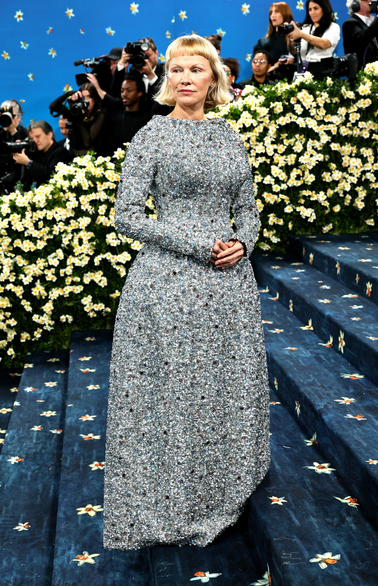 Pamela Anderson is seen on the Met Gala steps at the Metropolitan Museum of Art, holding her composure under the spotlight. The "Superfine" theme celebrated Black style through tailoring — with Anderson's appearance adding subtle grace to the night.