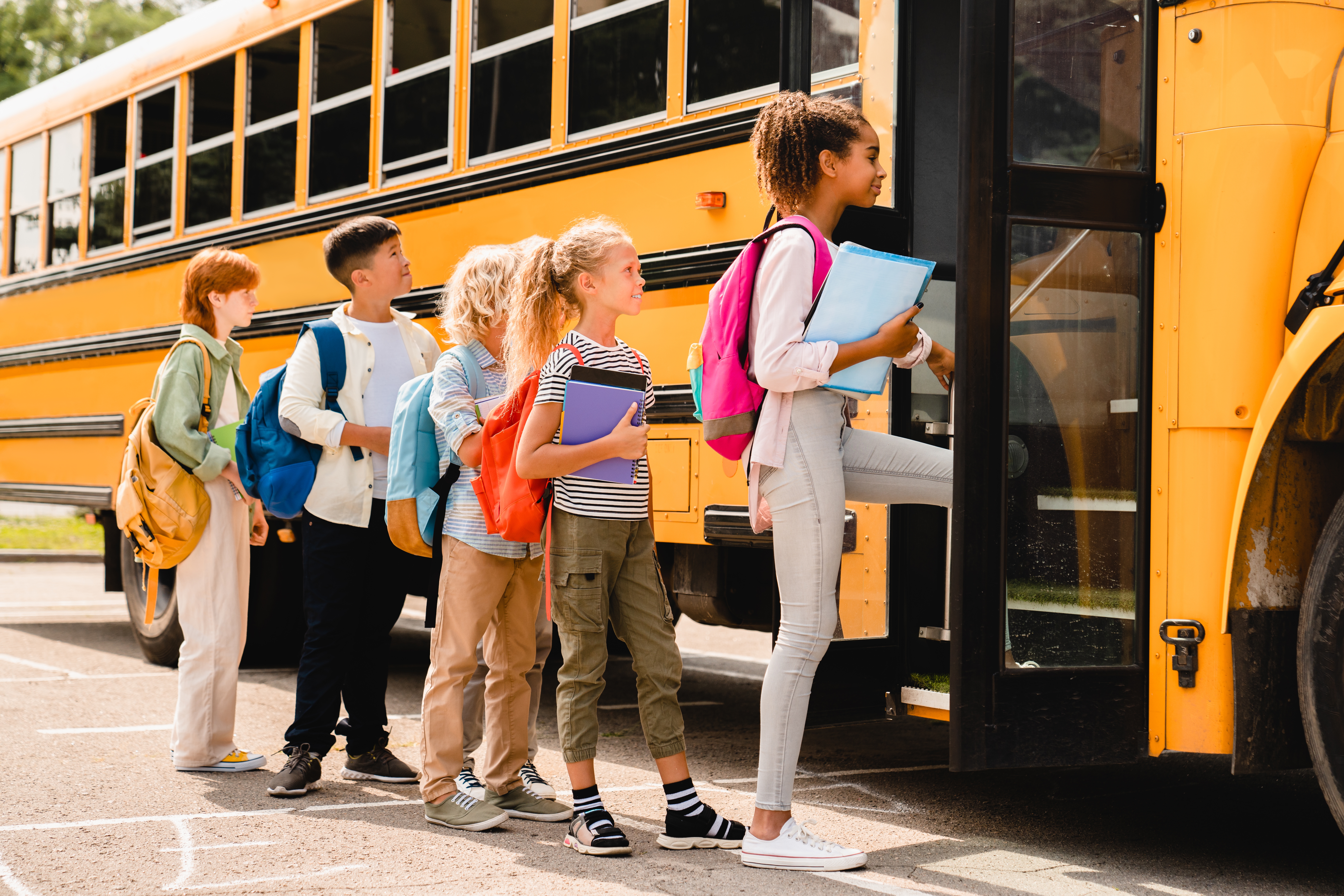 Children getting on a school bus | Source: Shutterstock