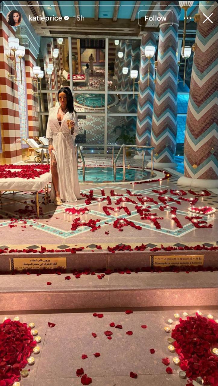 Katie Price pulled out all the stops for romance, posing inside a luxury Dubai hotel suite where rose petals and flickering candlelight spelled out "Will you marry me Katie?" in a scene straight from a romantic fantasy. | Source: Instagram/katieprice