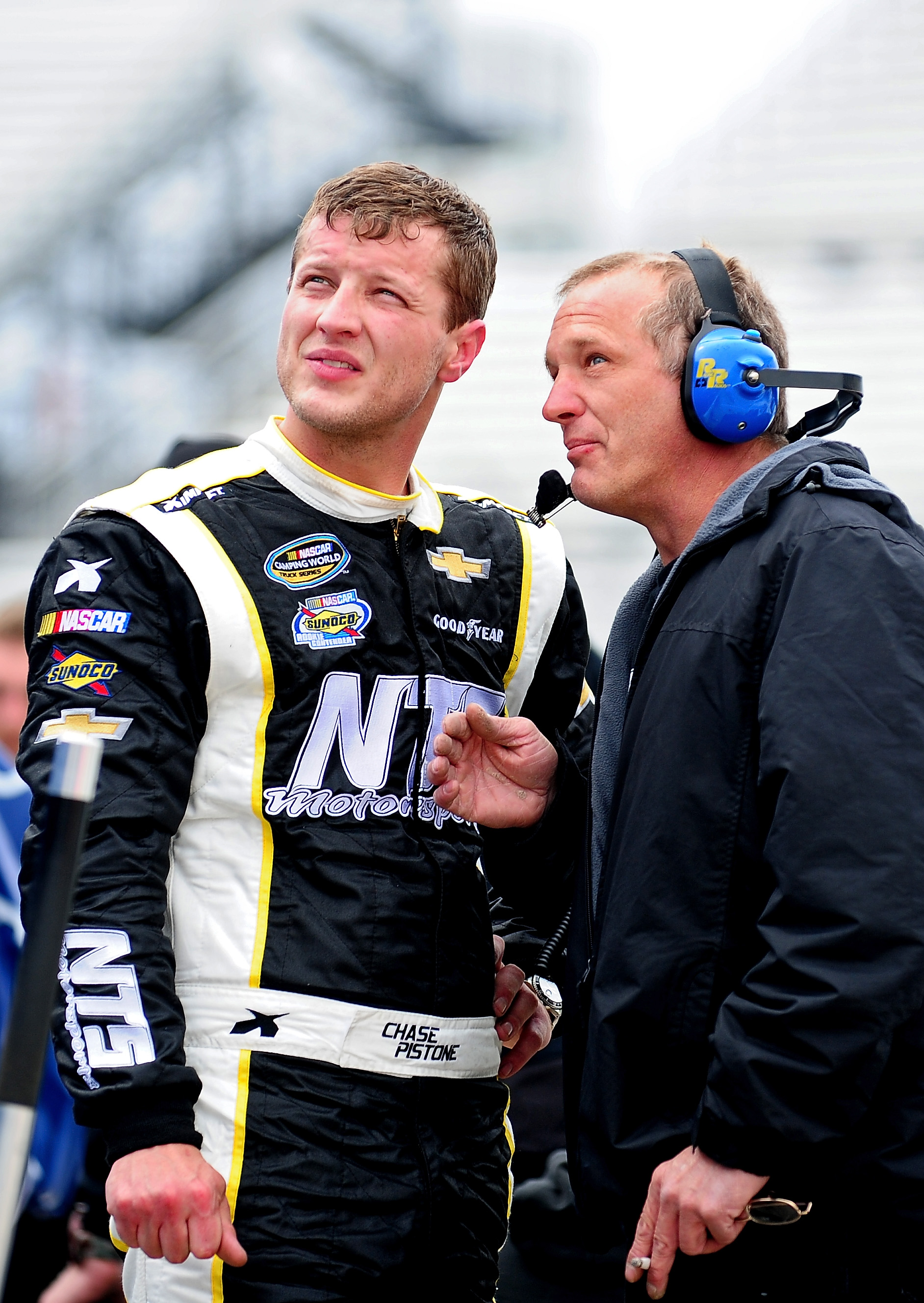 Chase Pistone talks with a crew member during practice at Martinsville Speedway in Martinsville, Virginia, on March 28, 2014 | Source: Getty Images