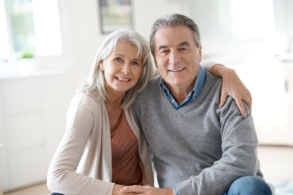 A portrait of senior couple relaxing on a sofa. | Photo: Shutterstock