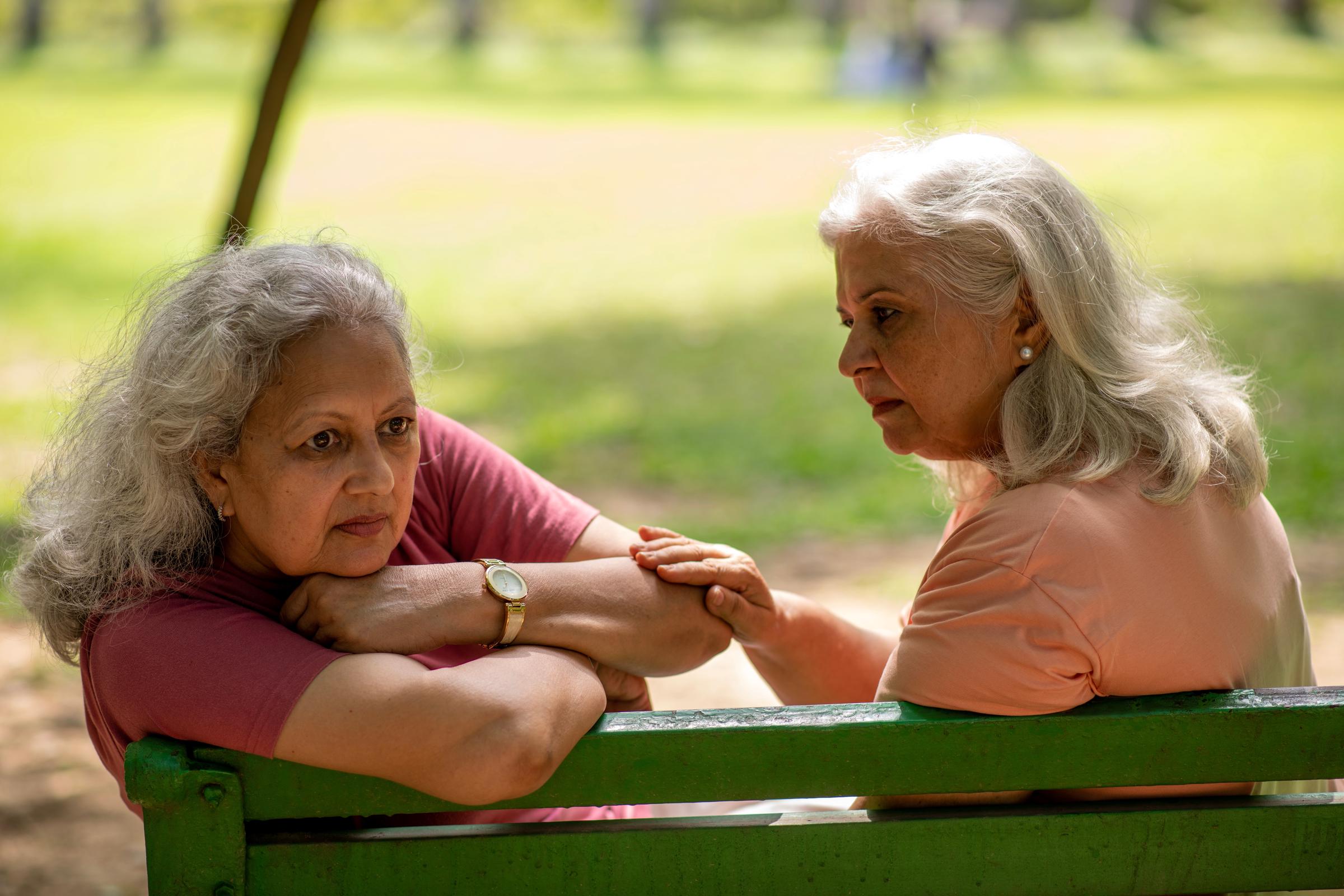 Woman consoling a grieving loved one at a park | Source: Shutterstock