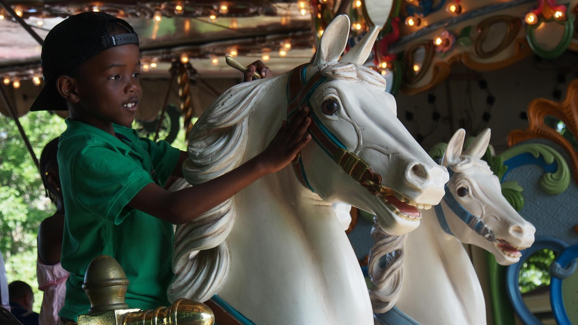 A little boy riding a carousel | Source: Pexels