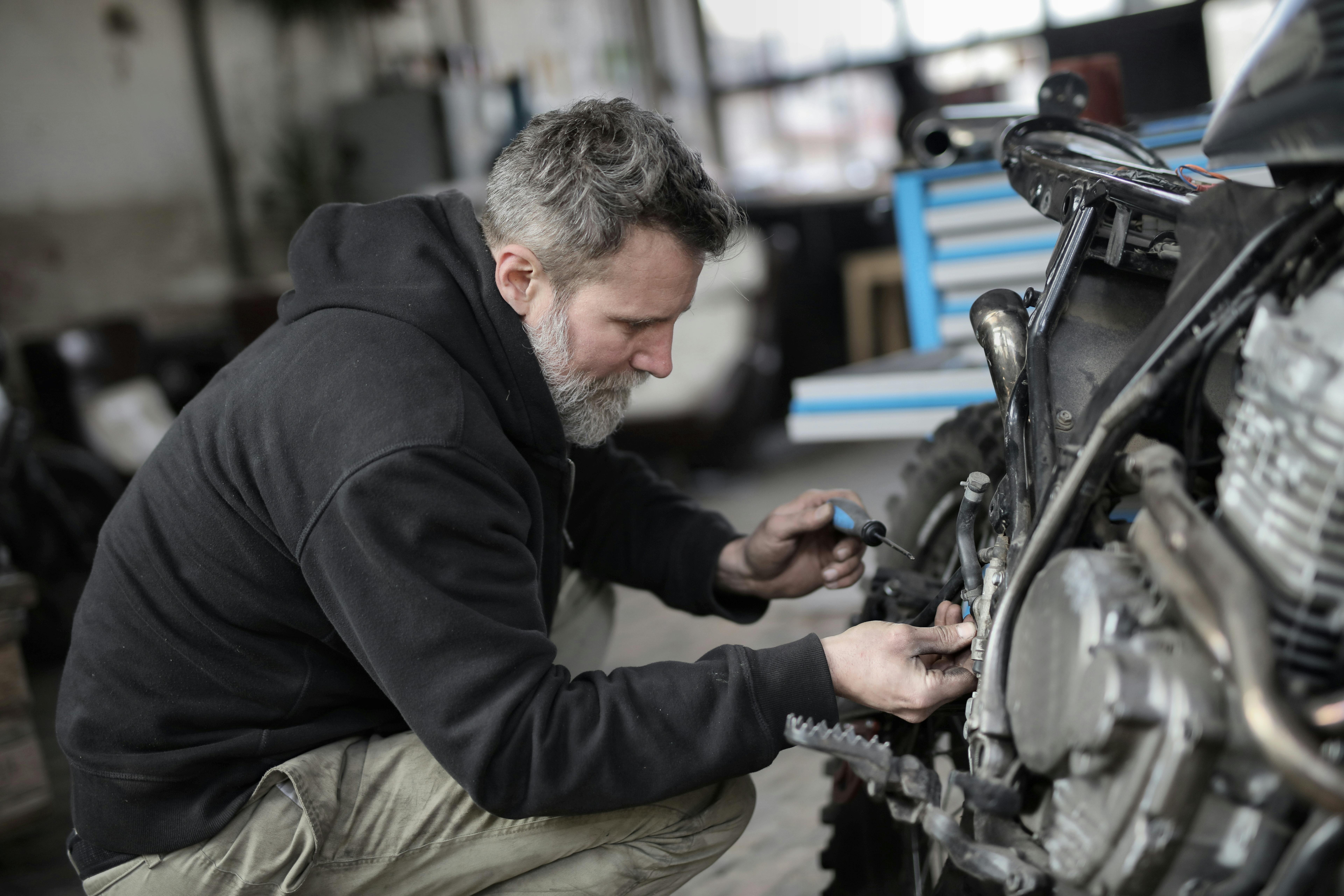 A man fixing a motorcycle | Source: Pexels