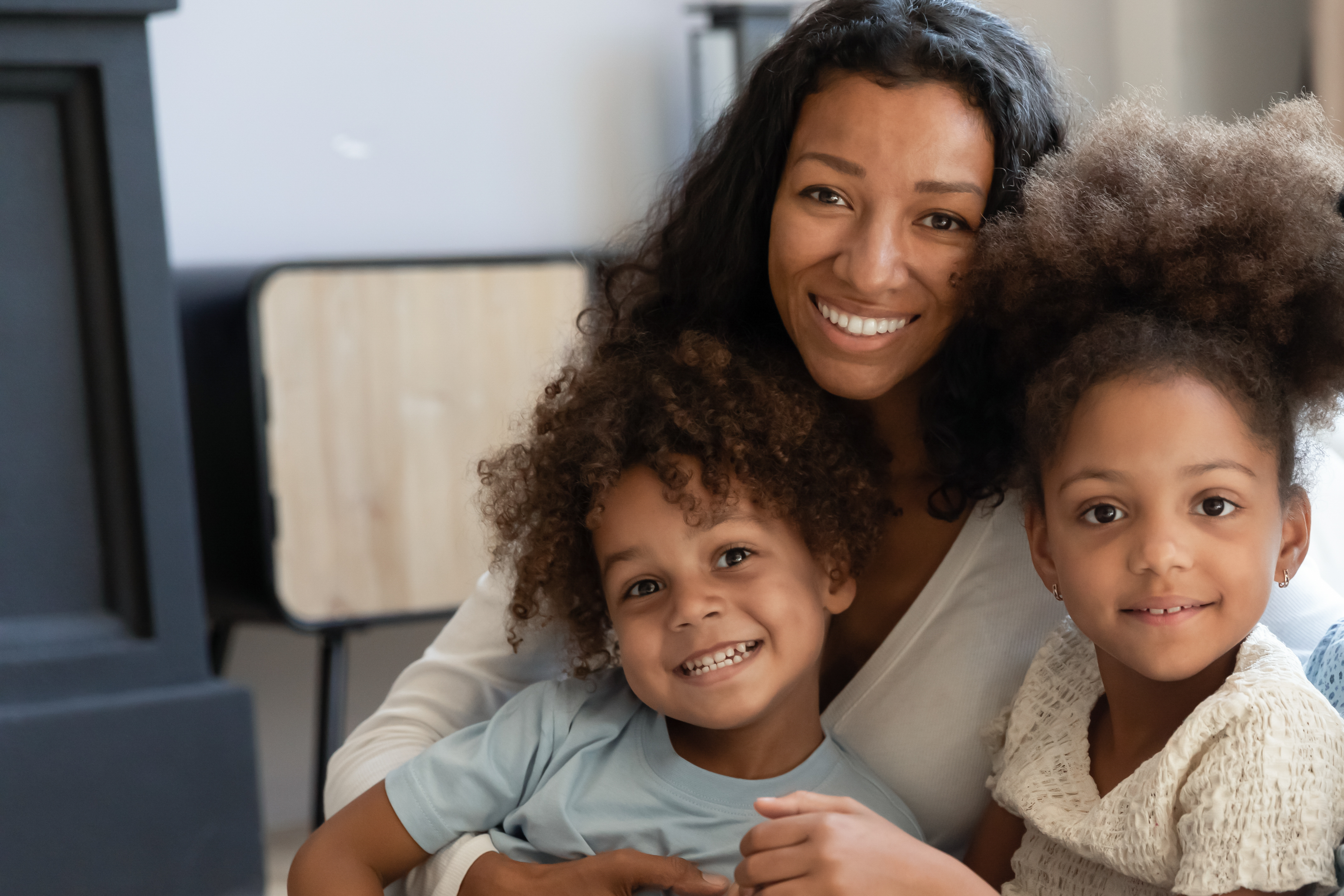 A black woman with two kids | Source: Shutterstock