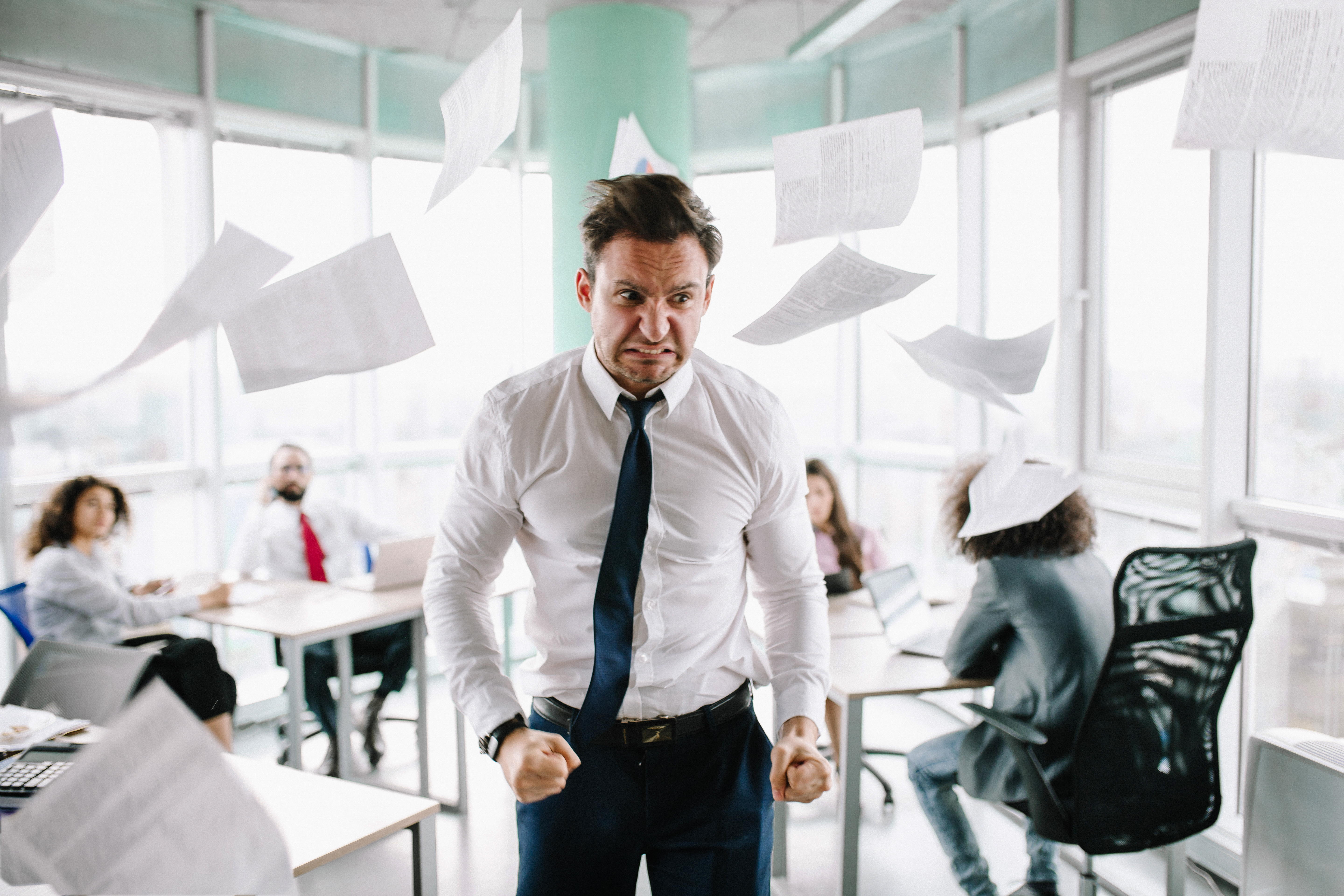 An angry man standing in an office | Source: Shutterstock