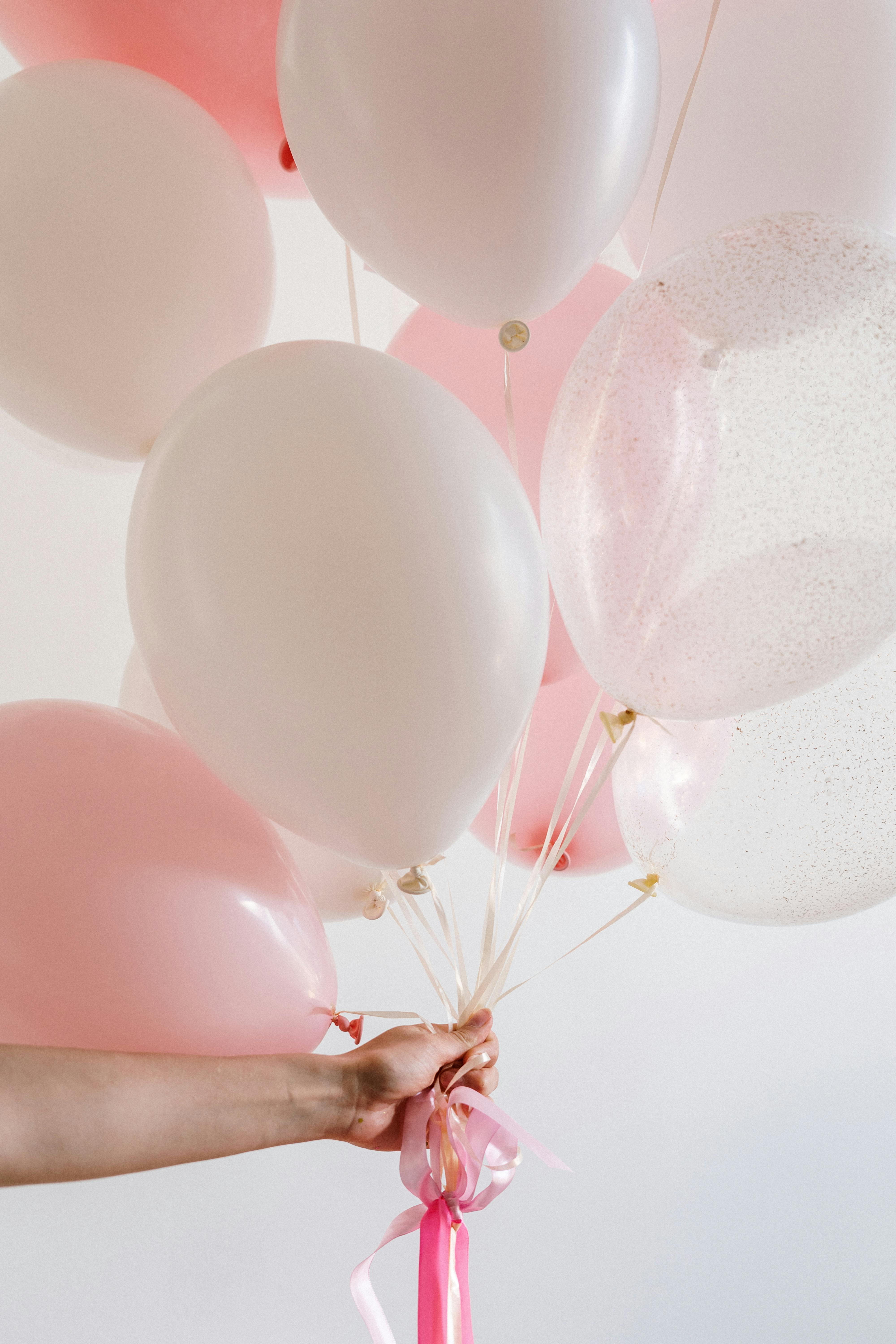 Hand with balloons | Source: Pexels