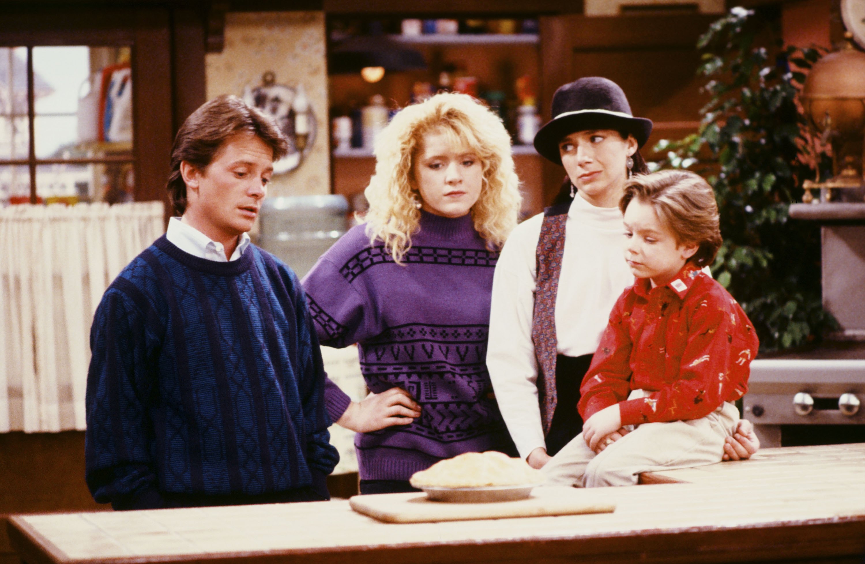 From (L-R) Michael J. Fox, Tina Yothers, Justine Bateman, and Brian Bonsall on the set of "Family Ties" | Source: Getty Images