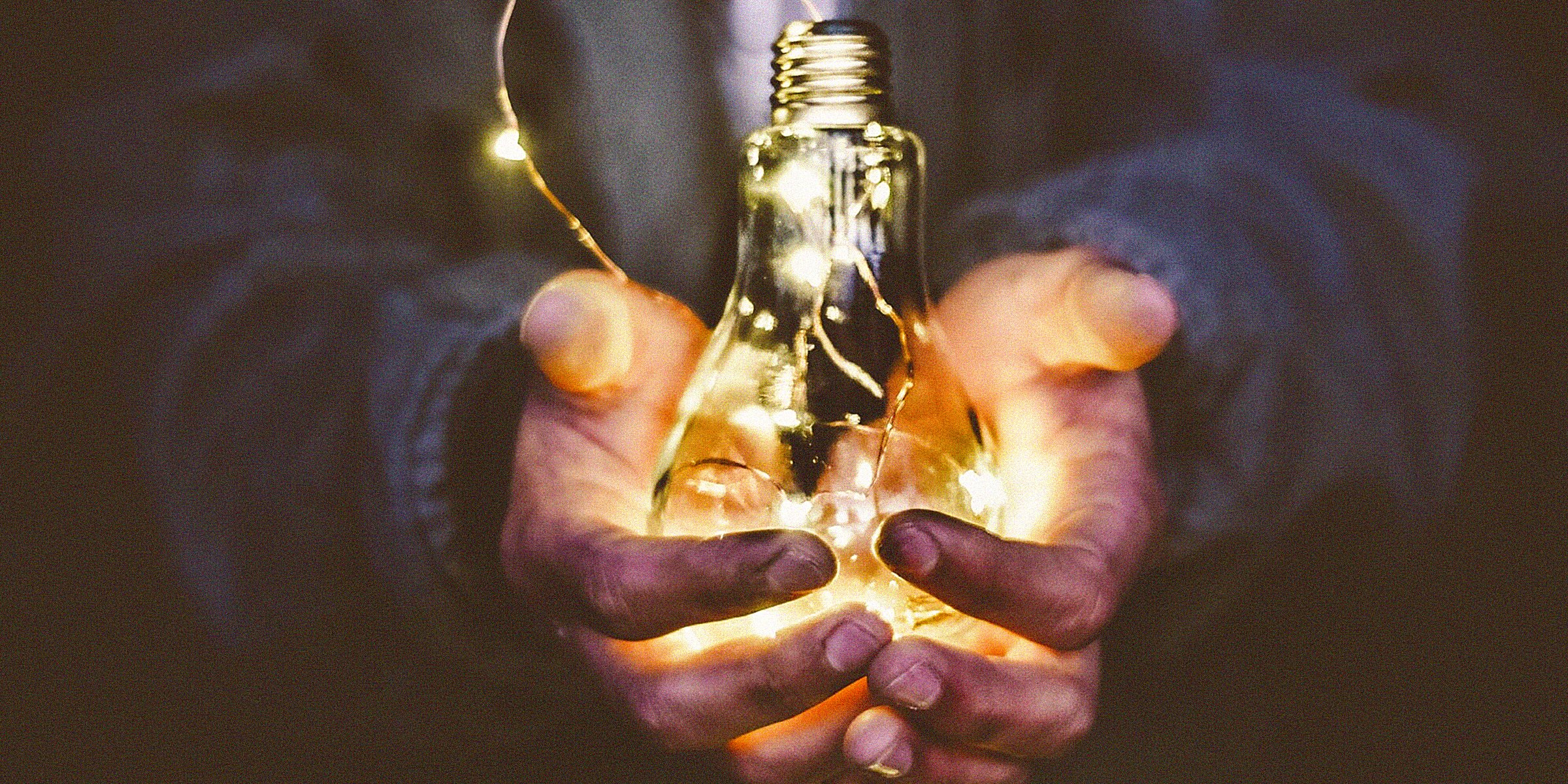 Unsplash | An individual holding a light bulb