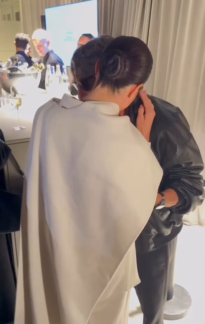 Meghan Markle whispering into designer Pierpaolo Piccioli's ear at Paris Fashion Week on October 4, 2025 | Source: Instagram/wwd