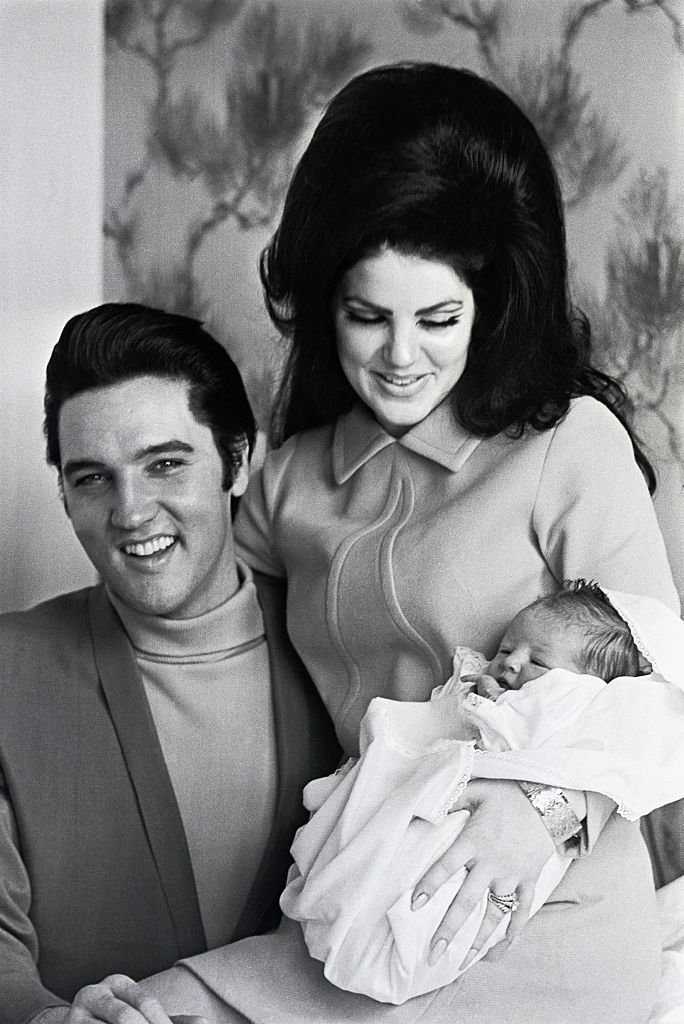 Elvis Presley and his wife, Priscilla Presley, smile as they hold their four-day-old daughter, Lisa Marie, before leaving Baptist Hospital, on February 07 1968, in Memphis Tennessee.