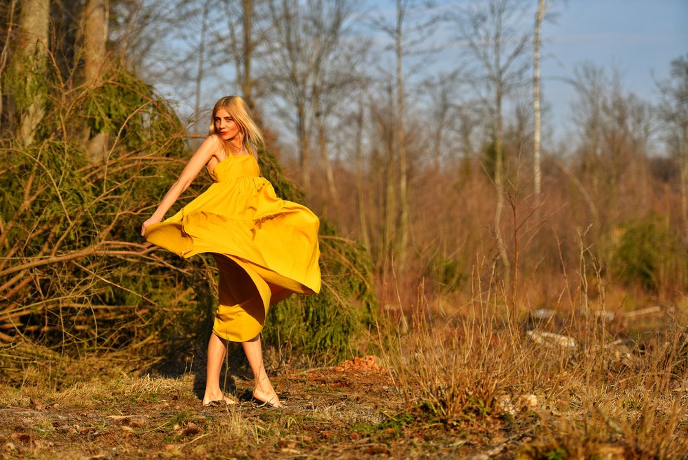 A photo of a woman in a mustard dress. | Photo: Shutterstock