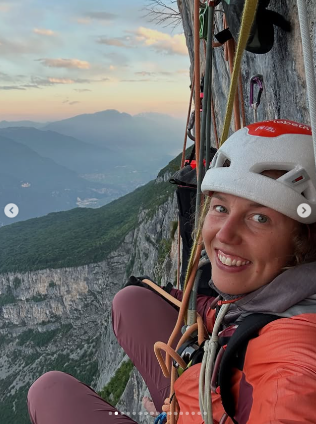 Laura Dahlmeier beams with a radiant smile while suspended on a sheer cliffside, from a post dated June 5, 2025 | Source: Instagram/laura_dahlmeier