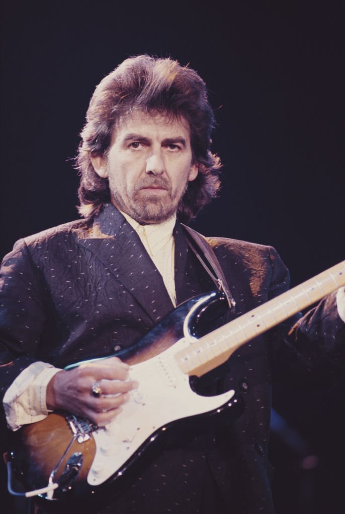 Former Beatle George Harrison (1943 - 2001) performing with a Fender Stratocaster guitar at the Prince's Trust Concert, Wembley Arena, London, | Getty Images / Global Images Ukraine Former Beatle George Harrison (1943 - 2001) performing with a Fender Stratocaster guitar at the Prince's Trust Concert, Wembley Arena, London, | Getty Images / Global Images Ukraine