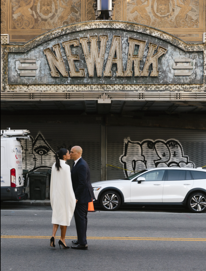 Cory Booker and Alexis Lewis share a kiss as they take photos on their wedding day, as seen from a post dated November 30, 2025. | Source: Facebook/CoryBooker