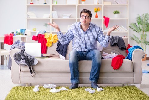 A man in a messy living room. | Source: Shutterstock.