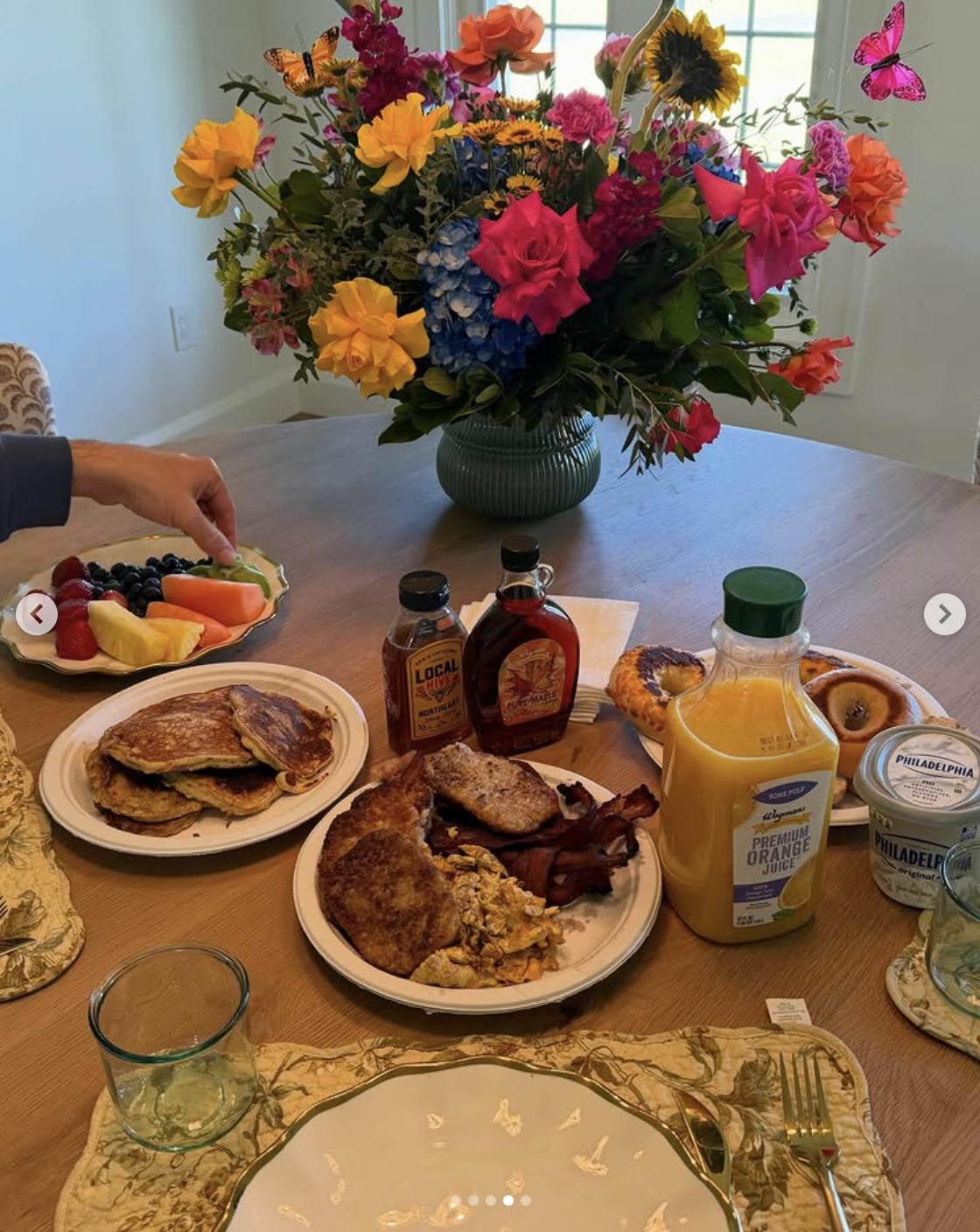 A breakfast spread with pancakes, fruit, flowers, and orange juice arranged on a table, posted on May 11, 2026 | Source: Instagram/haileesteinfeld