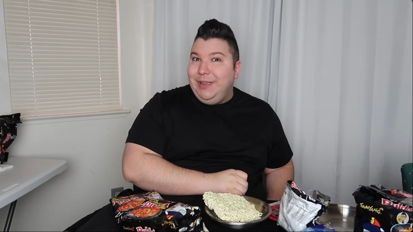 Nikocado Avocado sits down to prepare another mukbang in a video dated December 7, 2021, during the height of the fast-food content that defined his online persona and helped turn him into one of YouTube's most recognizable creators. | Source: YouTube/Nikocado Avocado