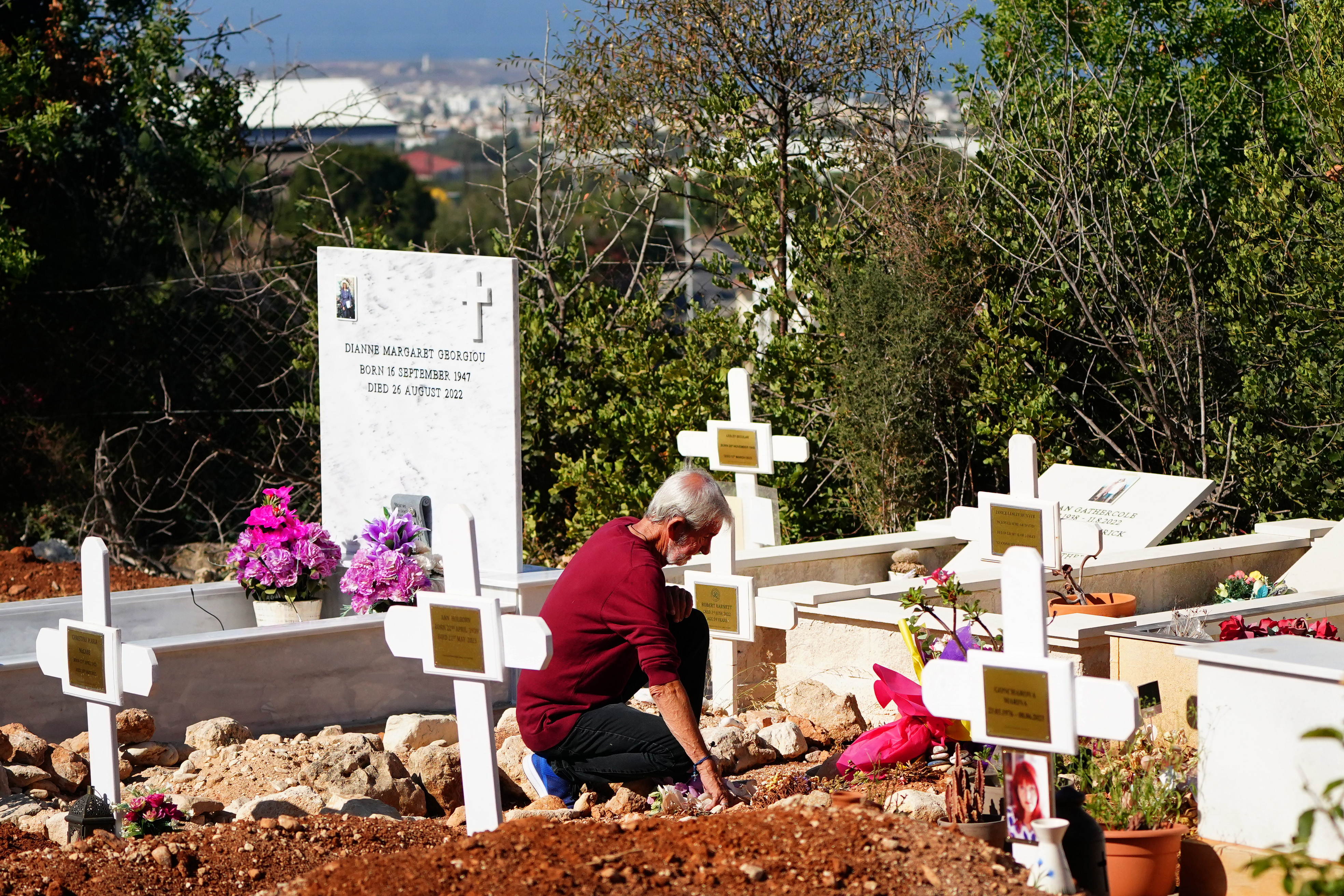 David Hunter kniet vor dem Grab seiner Frau auf einem Friedhof in Paphos, Zypern am 1. August 2023 | Quelle: Getty Images