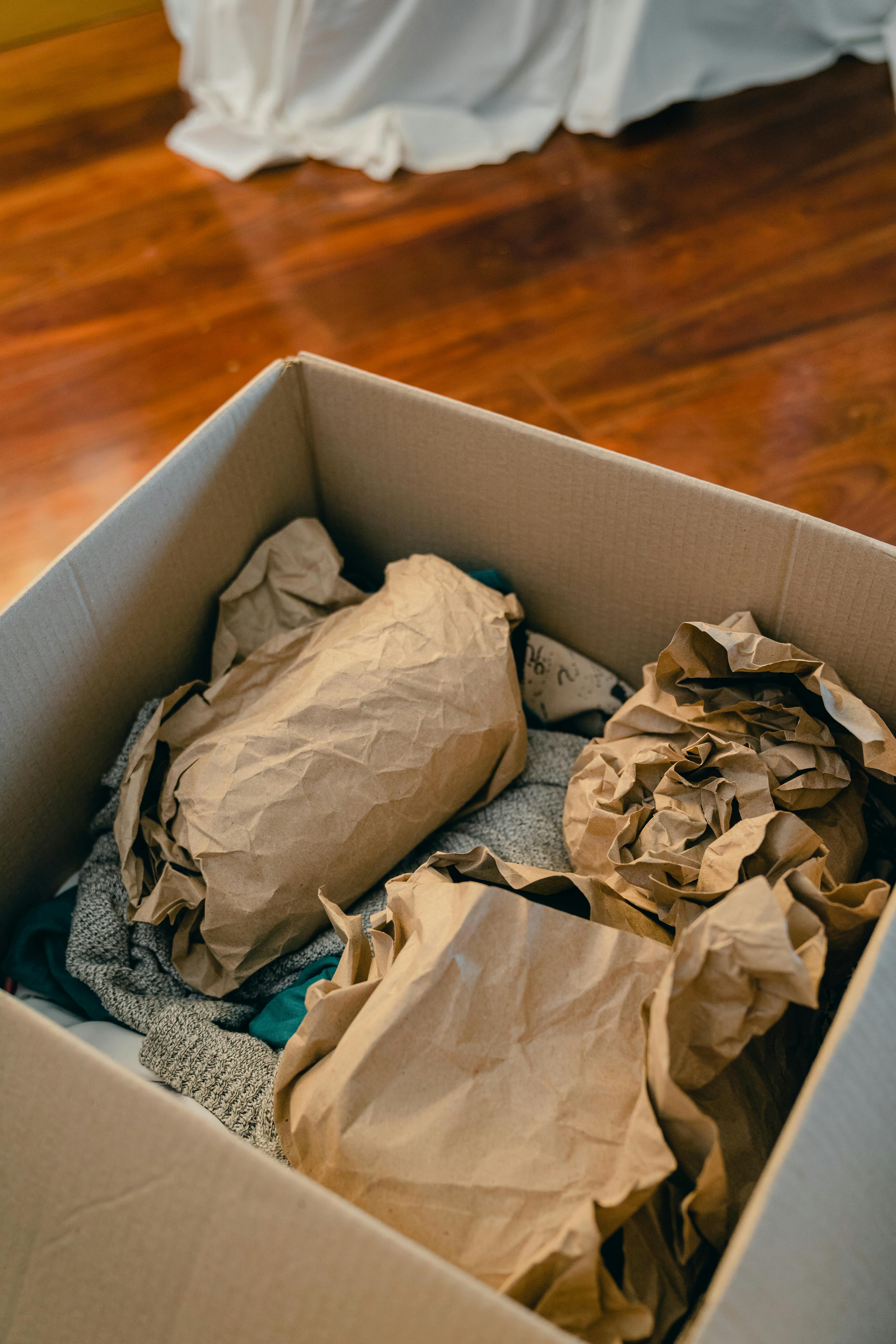 A box with objects wrapped in brown paper | Source: Pexels