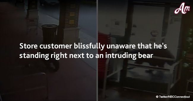 Store customer blissfully unaware that he's standing right next to an intruding bear 