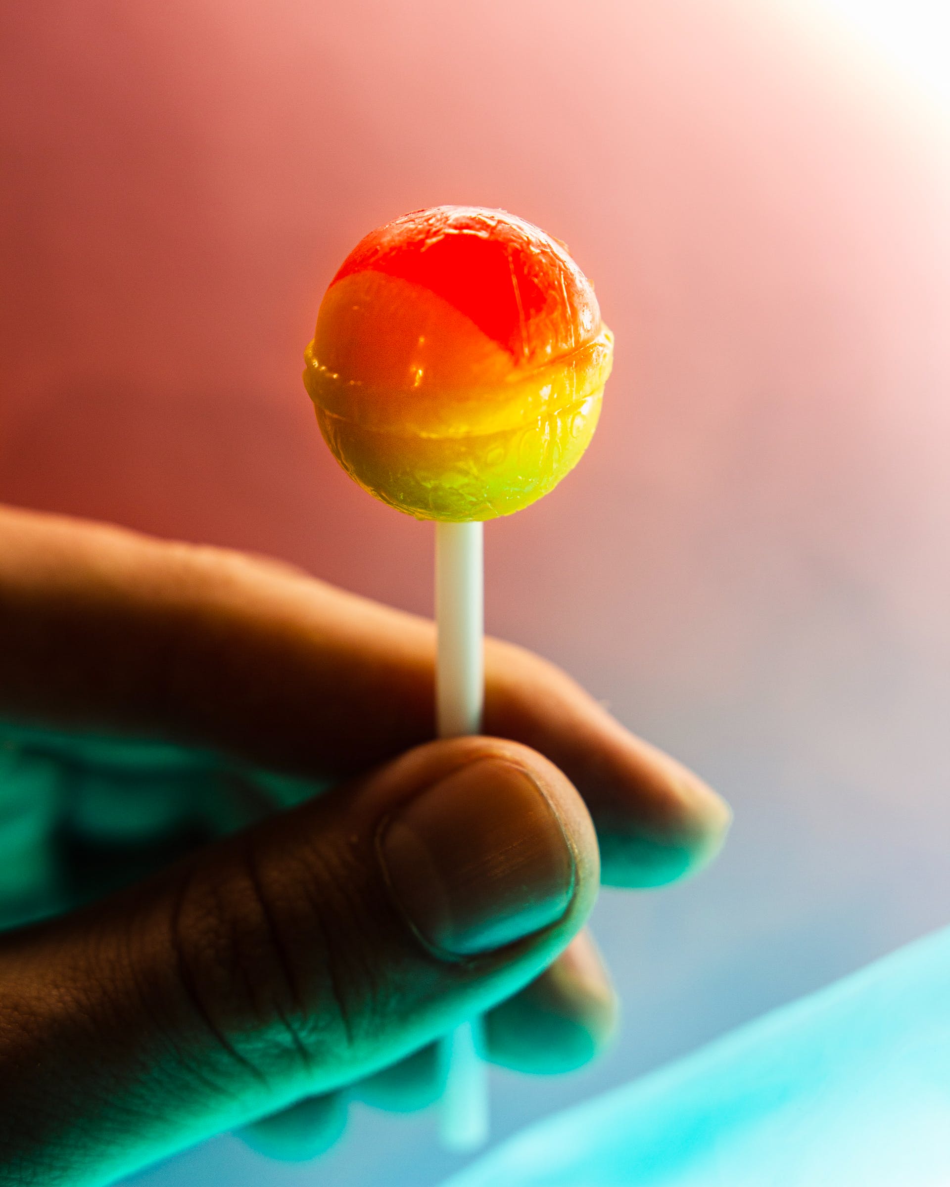 Person holding a lollipop | Source: Pexels