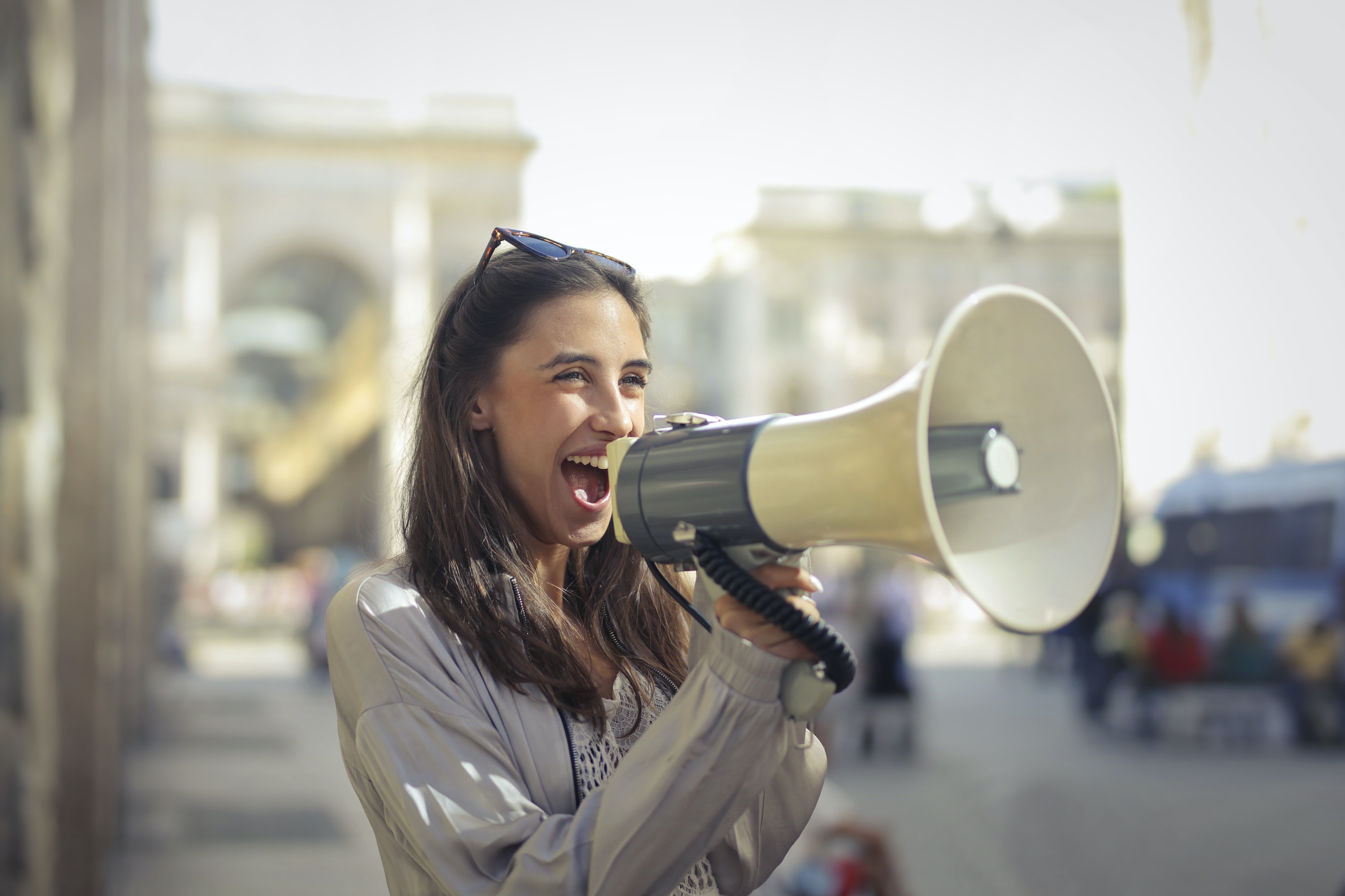 Woman yelling through a megaphone. | Source: Pexels