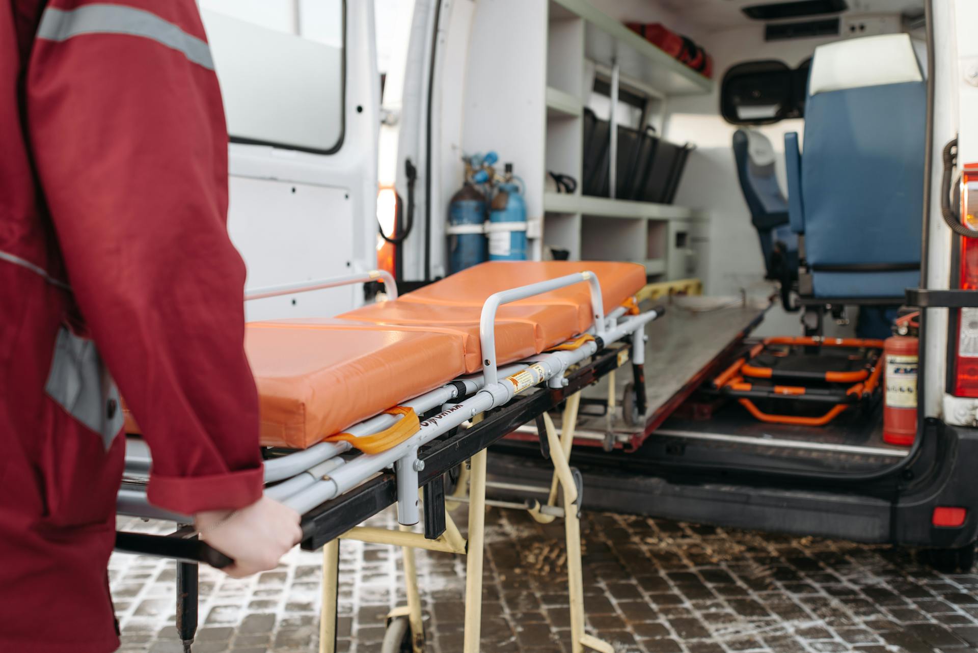 A paramedic pulling out a stretcher | Source: Pexels