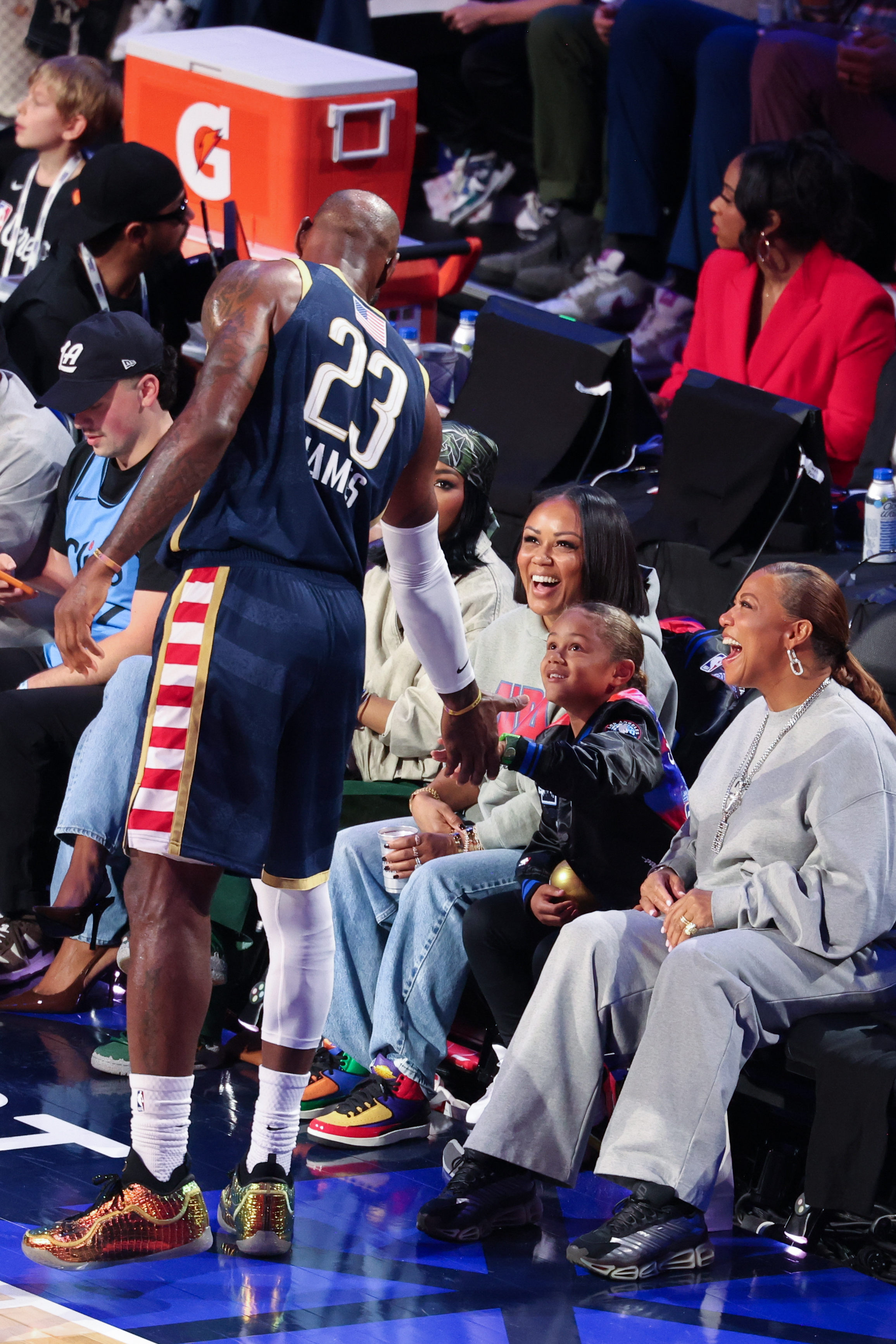 LeBron James, Eboni Nichols and Queen Latifah with Rebel are at the NBA All-Star Game held at the Intuit Dome in Los Angeles, California on February 15, 2026. | Source: Getty Images