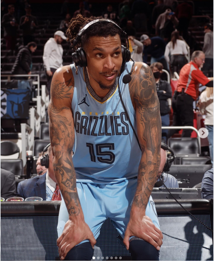 Brandon Clarke leans forward during a postgame interview while wearing his Memphis Grizzlies uniform and headset on the court. | Source: Instagram/brandon_clarke23